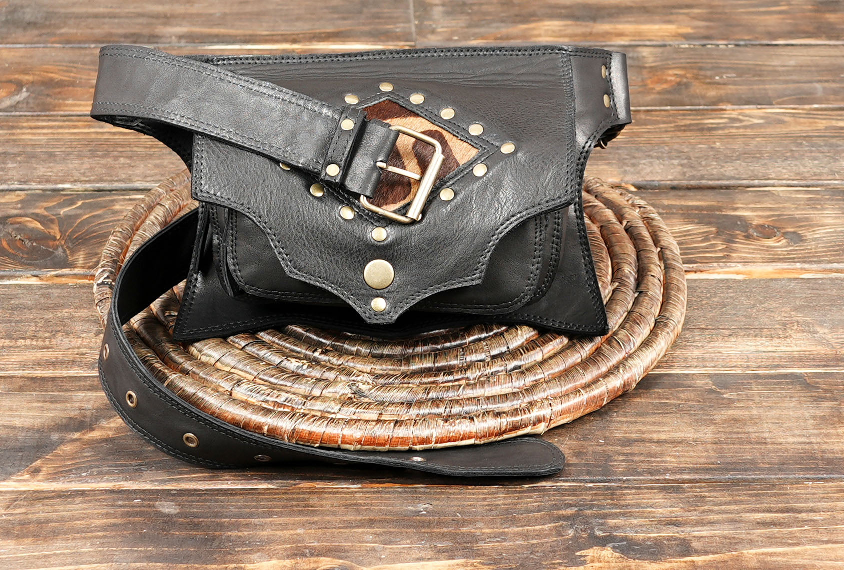 Handcrafted black leather belt bag with adjustable strap and rivets