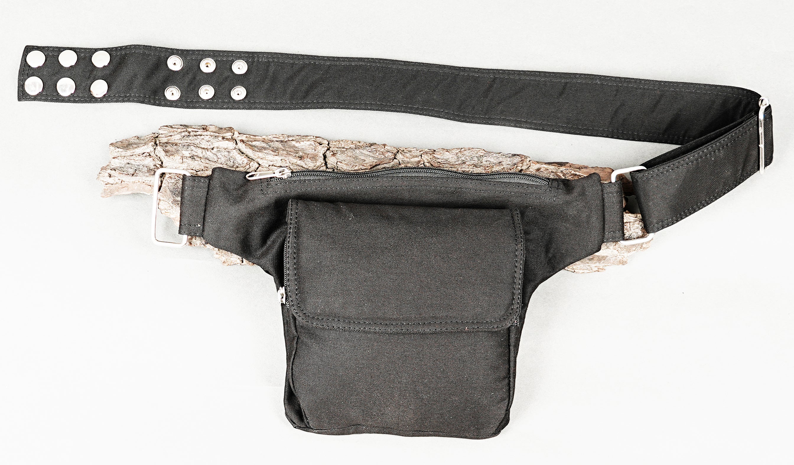Durable black fabric fanny pack with a fold-over flap pocket and zip top.
