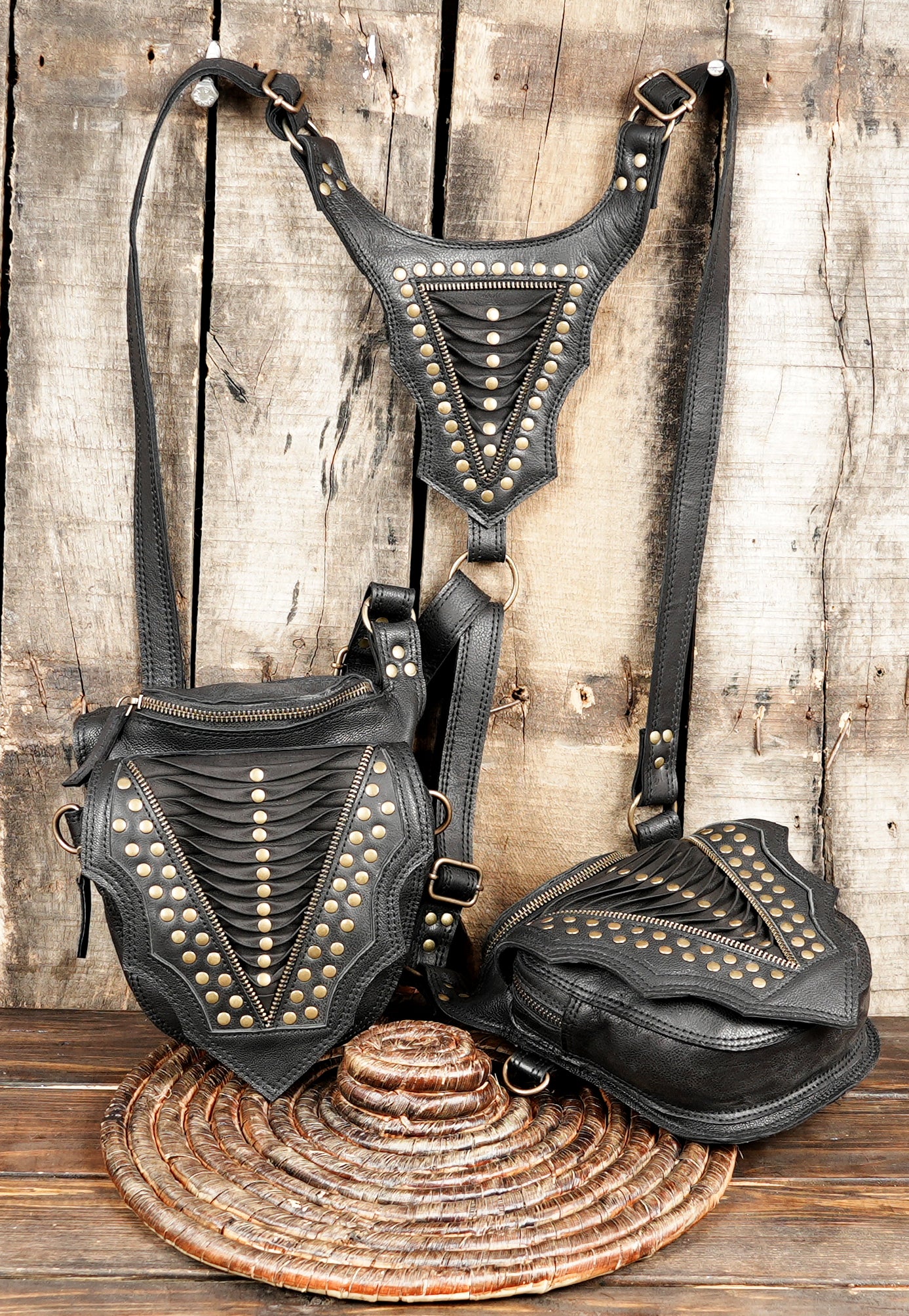 “Black leather shoulder holster with zipper pockets and geometric panel work”