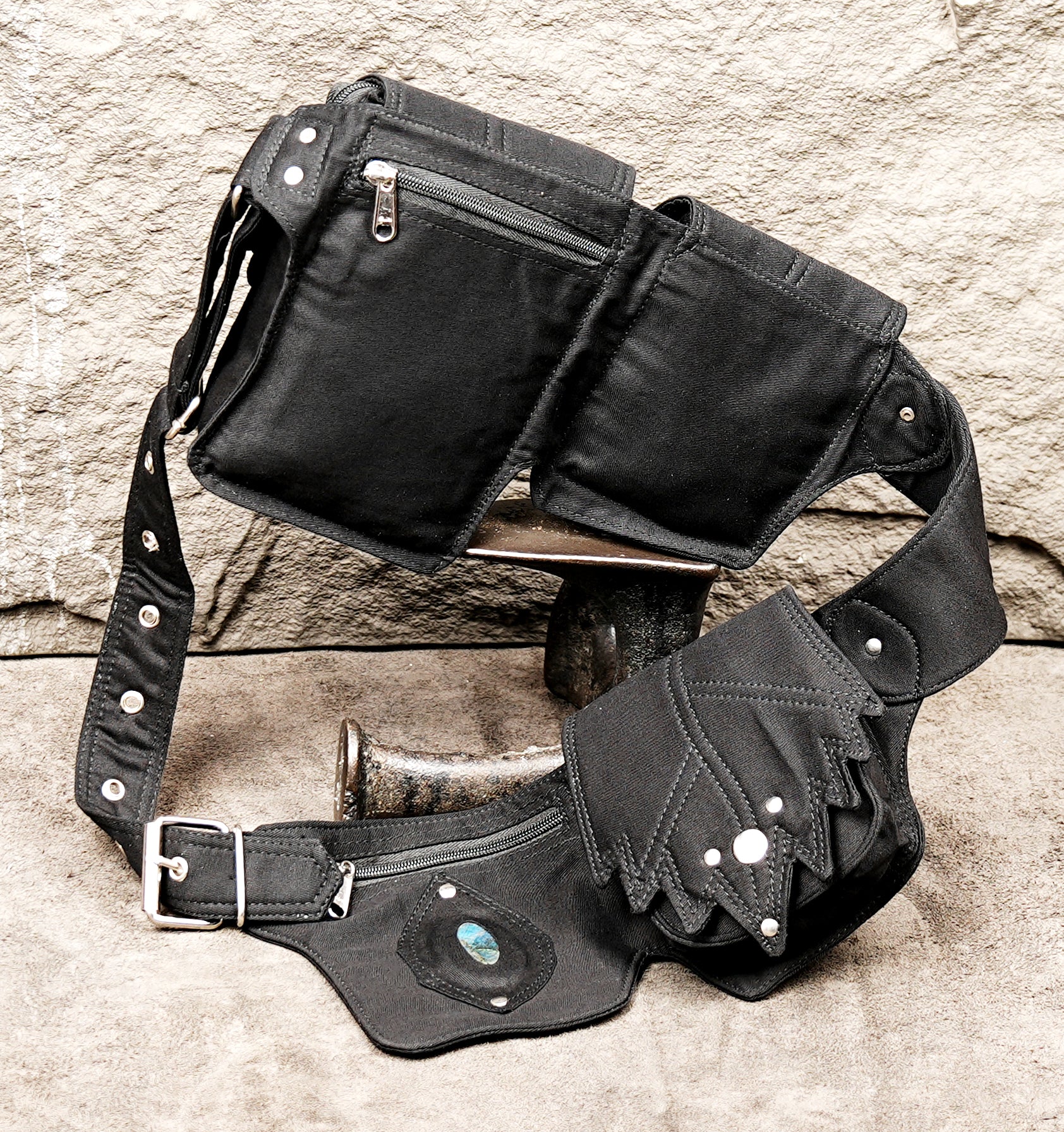 Steampunk adventurer utility belt with multiple canvas pockets and rivet details.