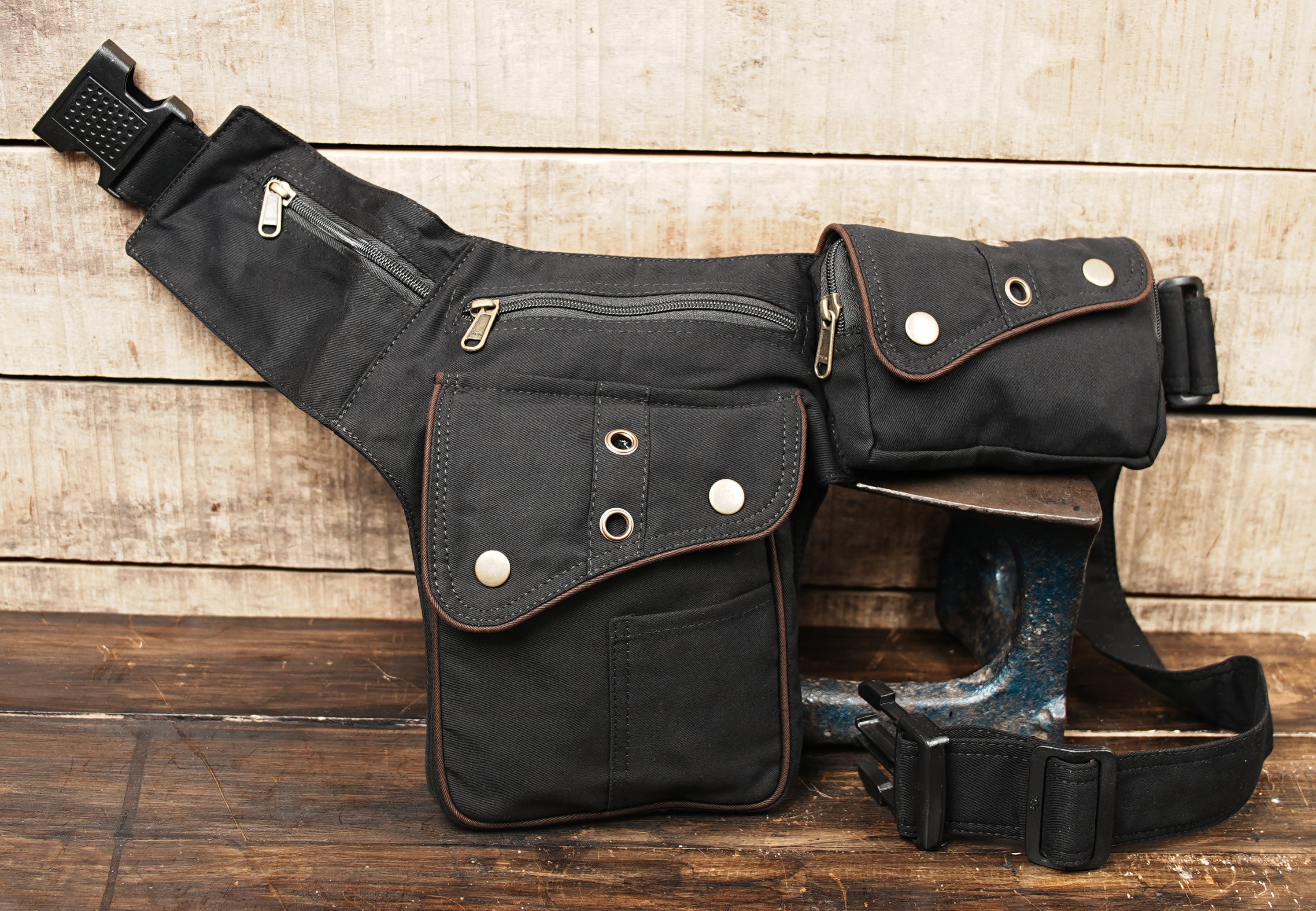 Brown leather waist bag with brass studs and detailed stitching