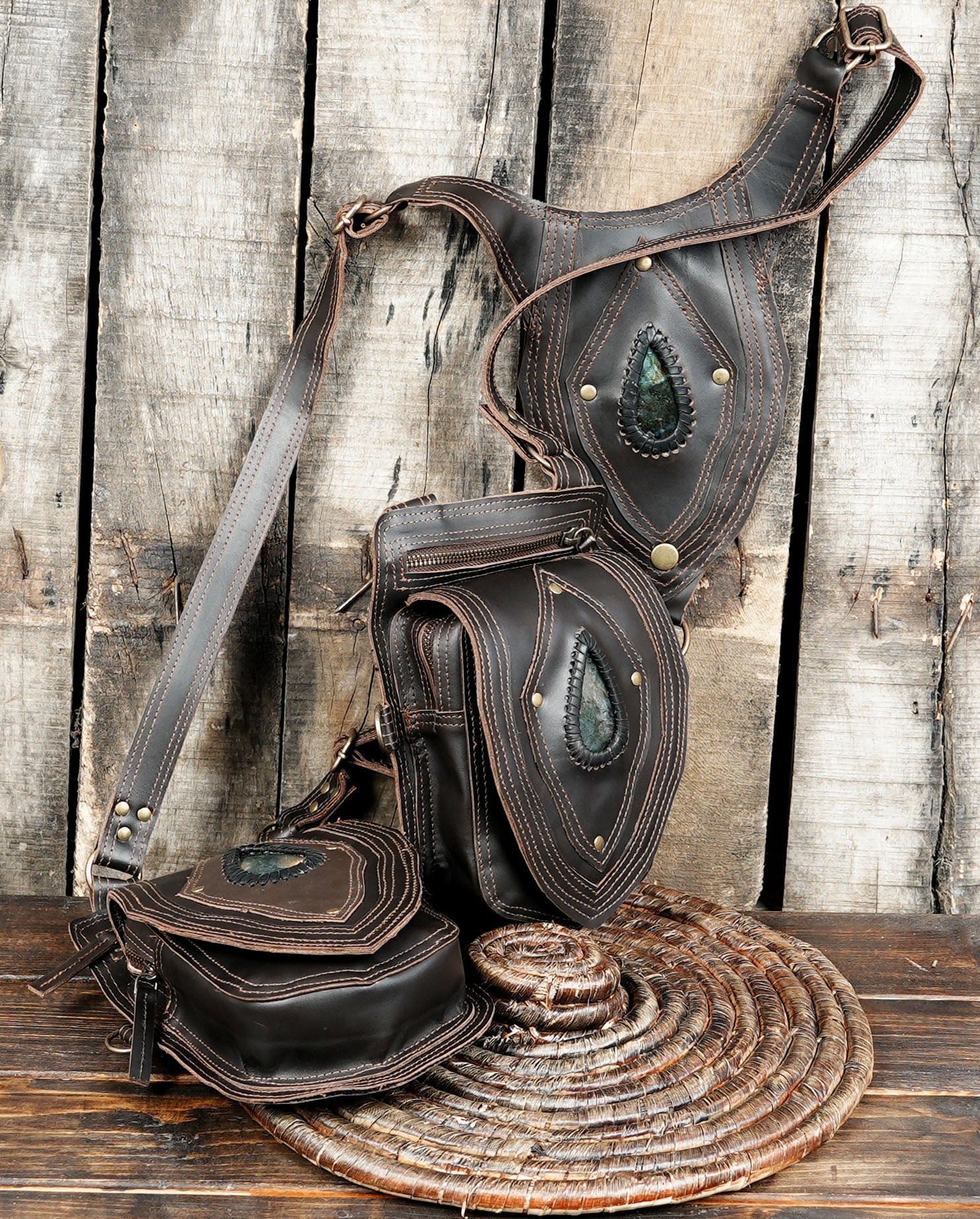 Brown leather dual holster bag on rustic wood background