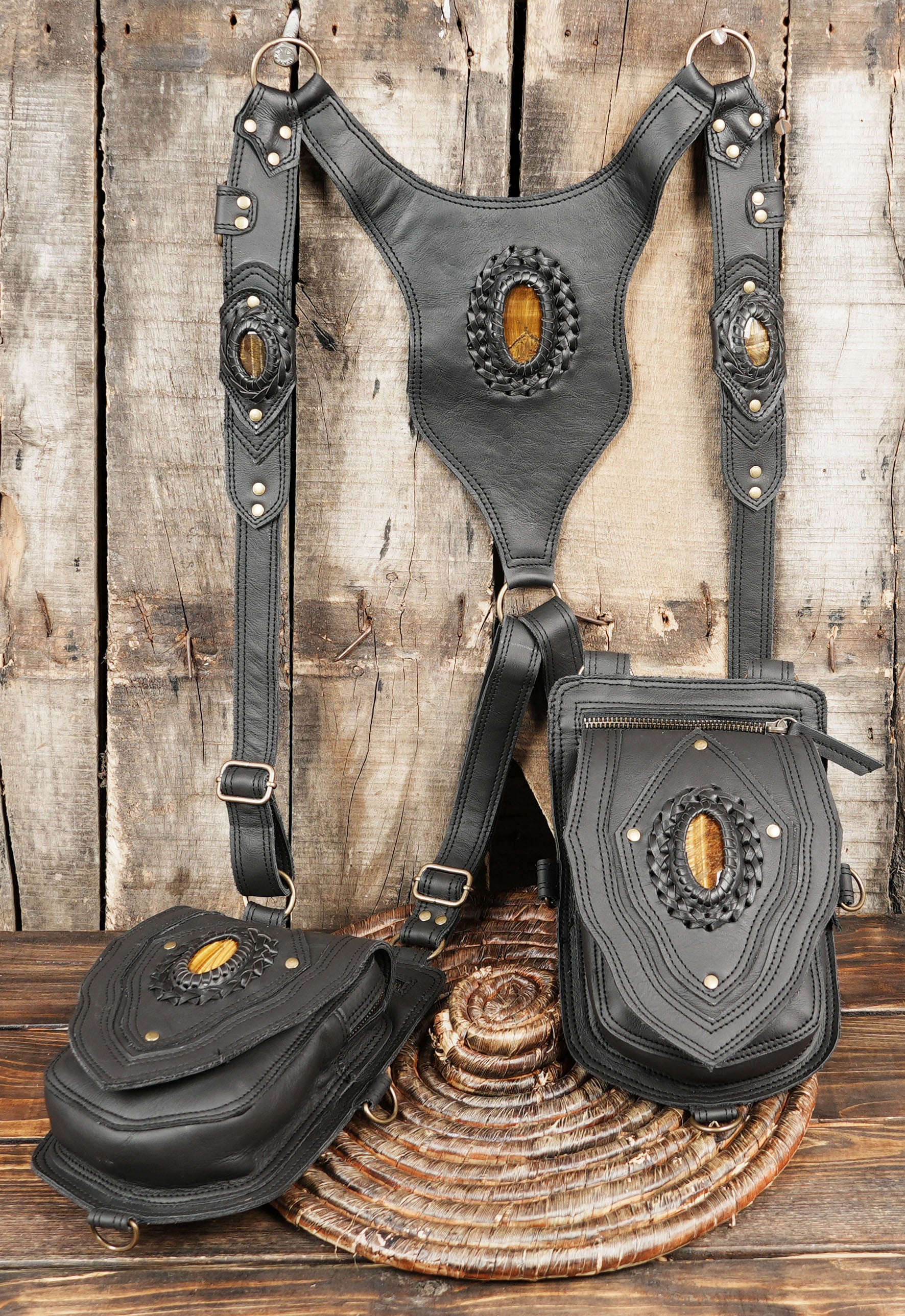 Back panel of black leather holster bag with adjustable straps