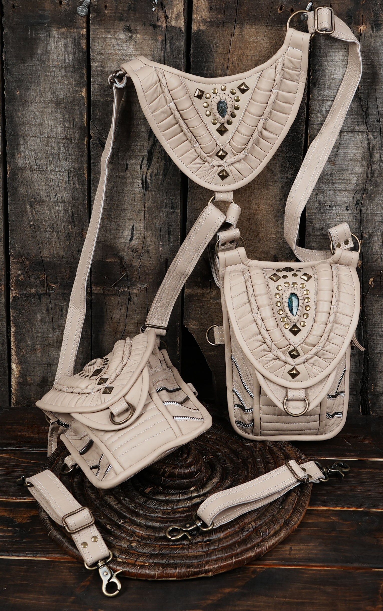 “Ivory dual pouch leather holster with ornate tribal-style detailing”