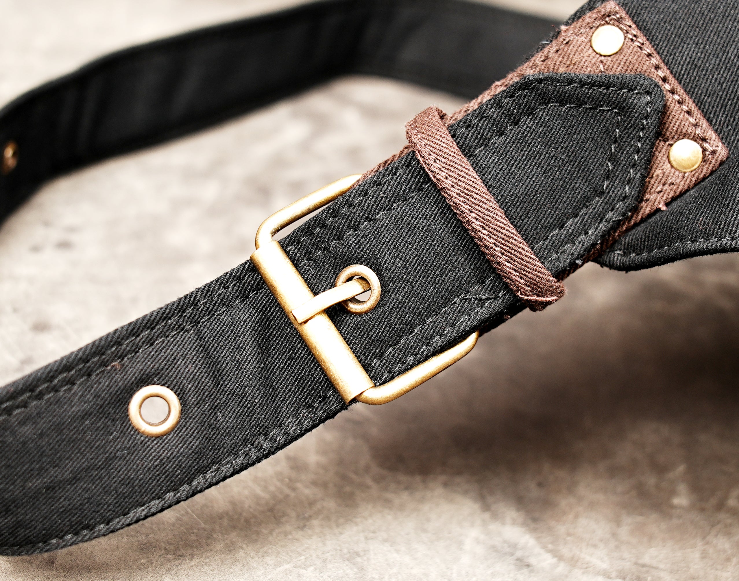 Adjustable black cotton hip bag with antique brass fittings