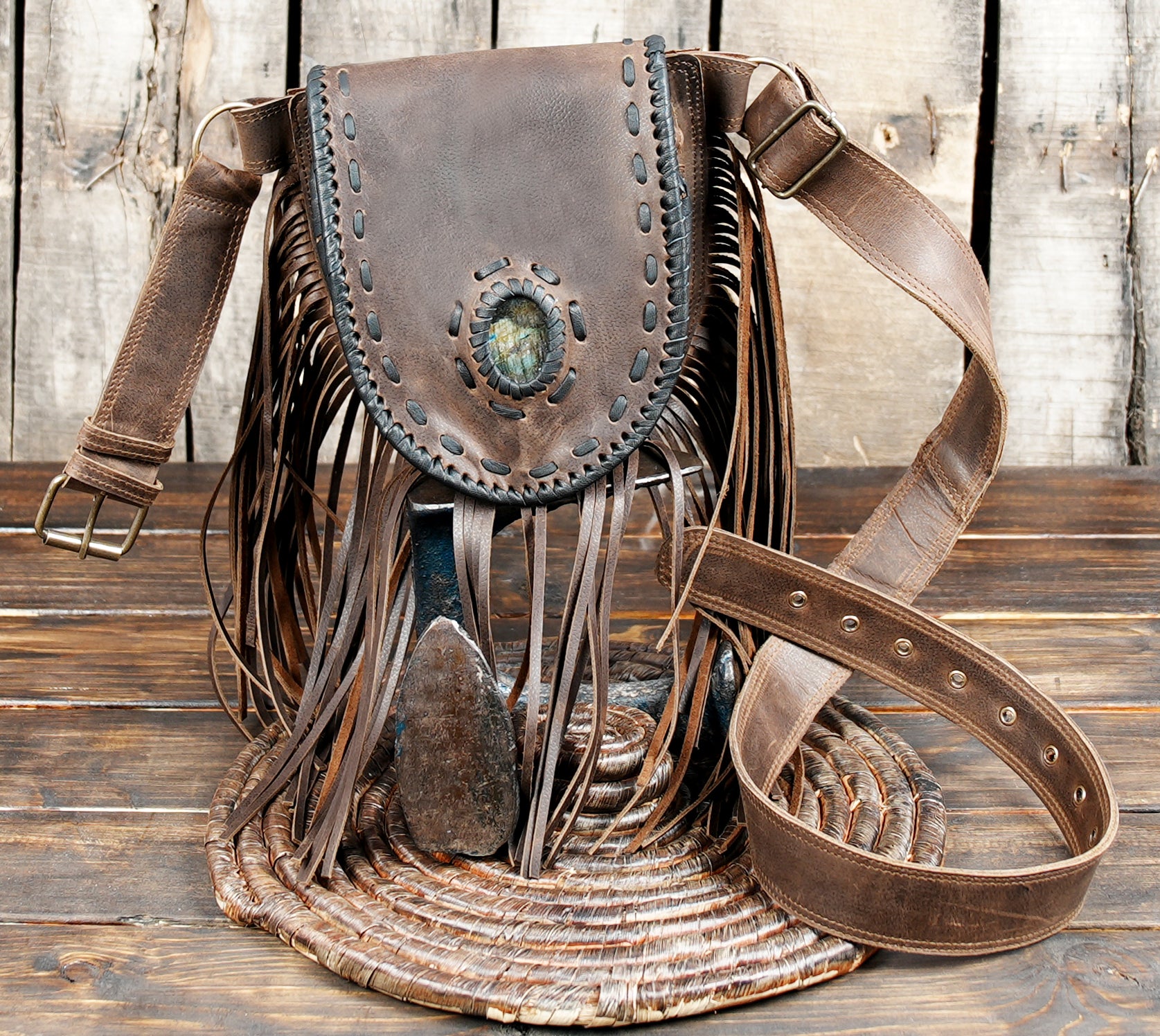 Handcrafted brown leather waist pouch with long fringe and stone accent