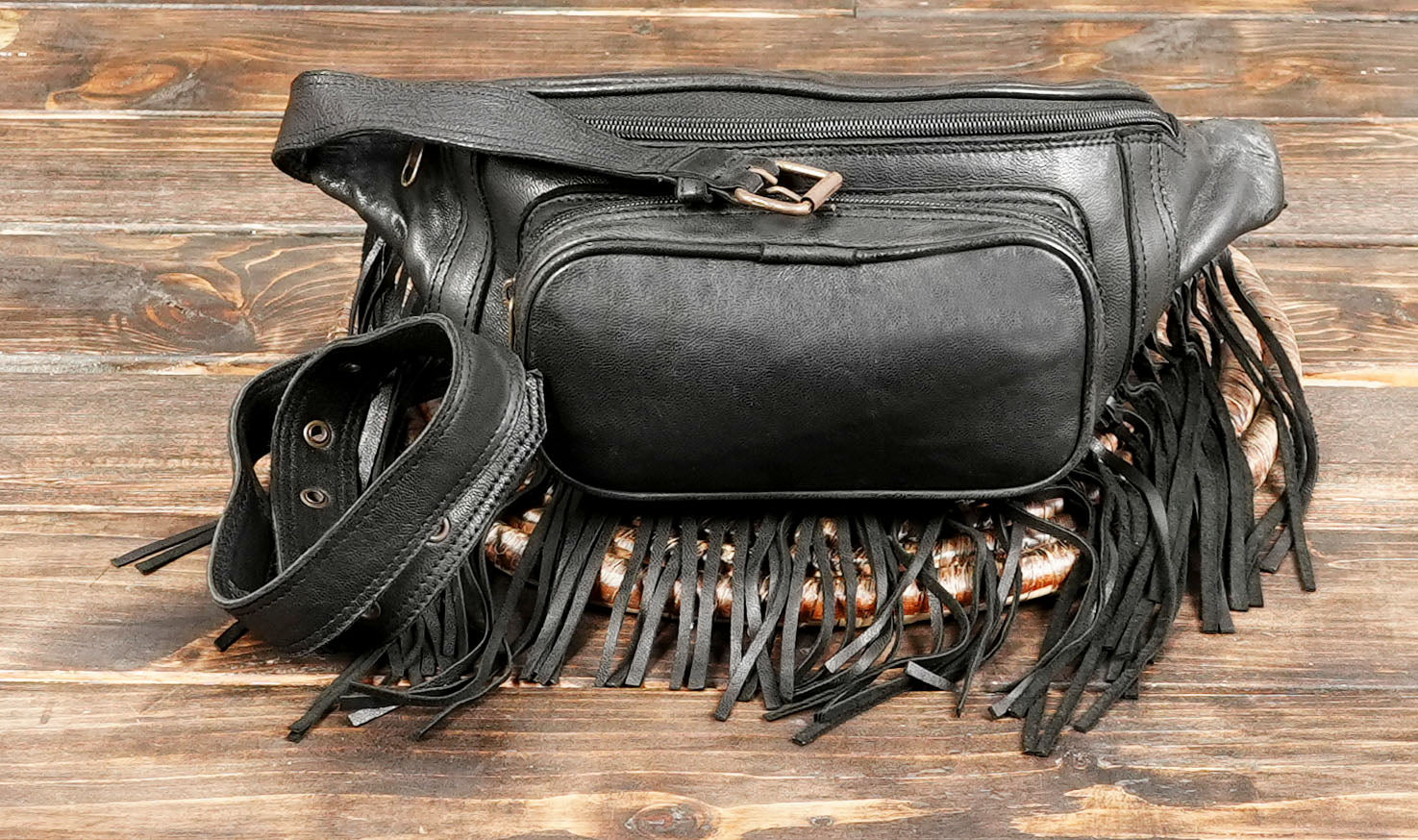 Black leather crossbody waist bag with fringe accents