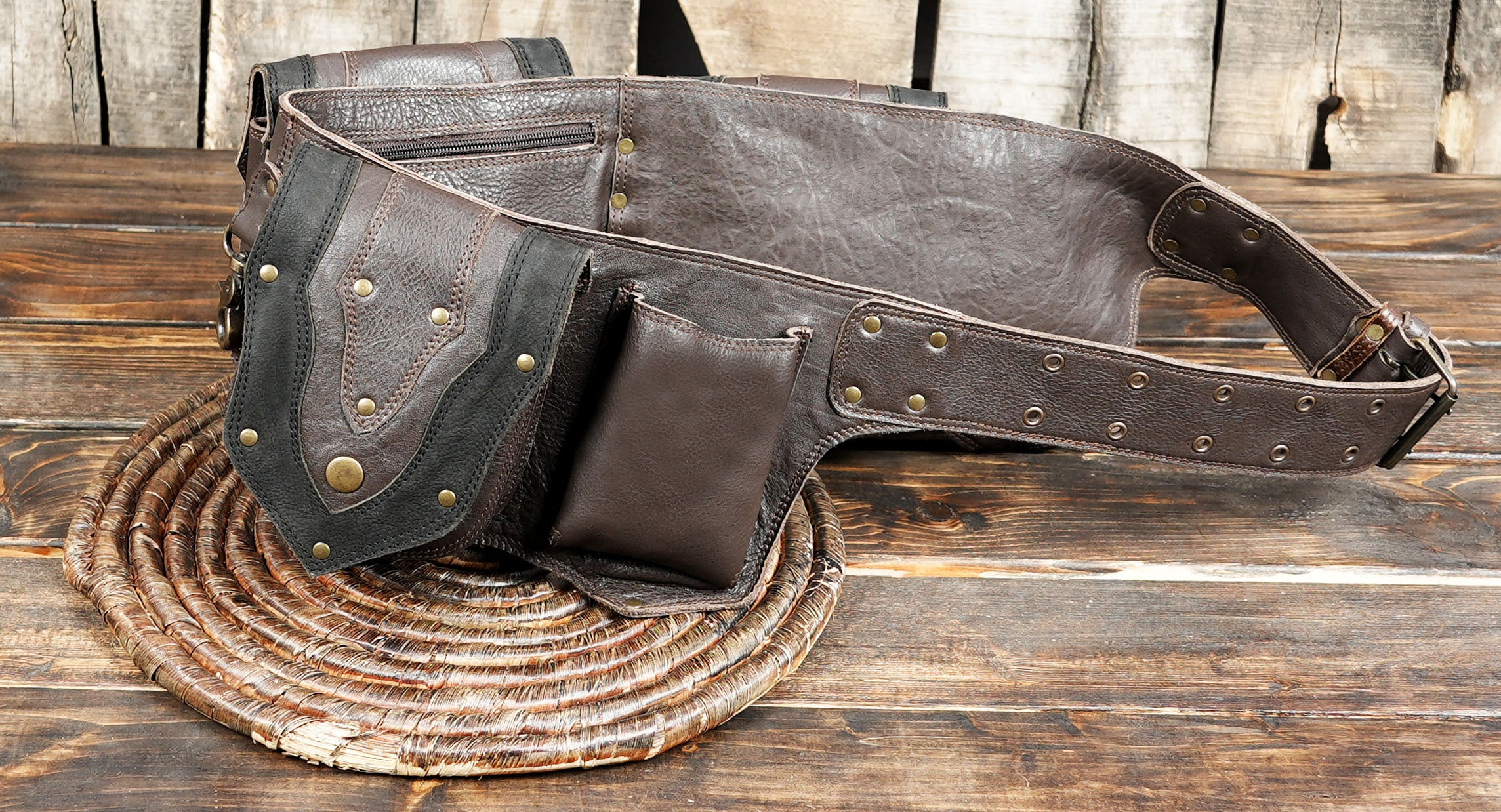 Handmade brown leather waist belt with multiple pouches and rivet detailing.