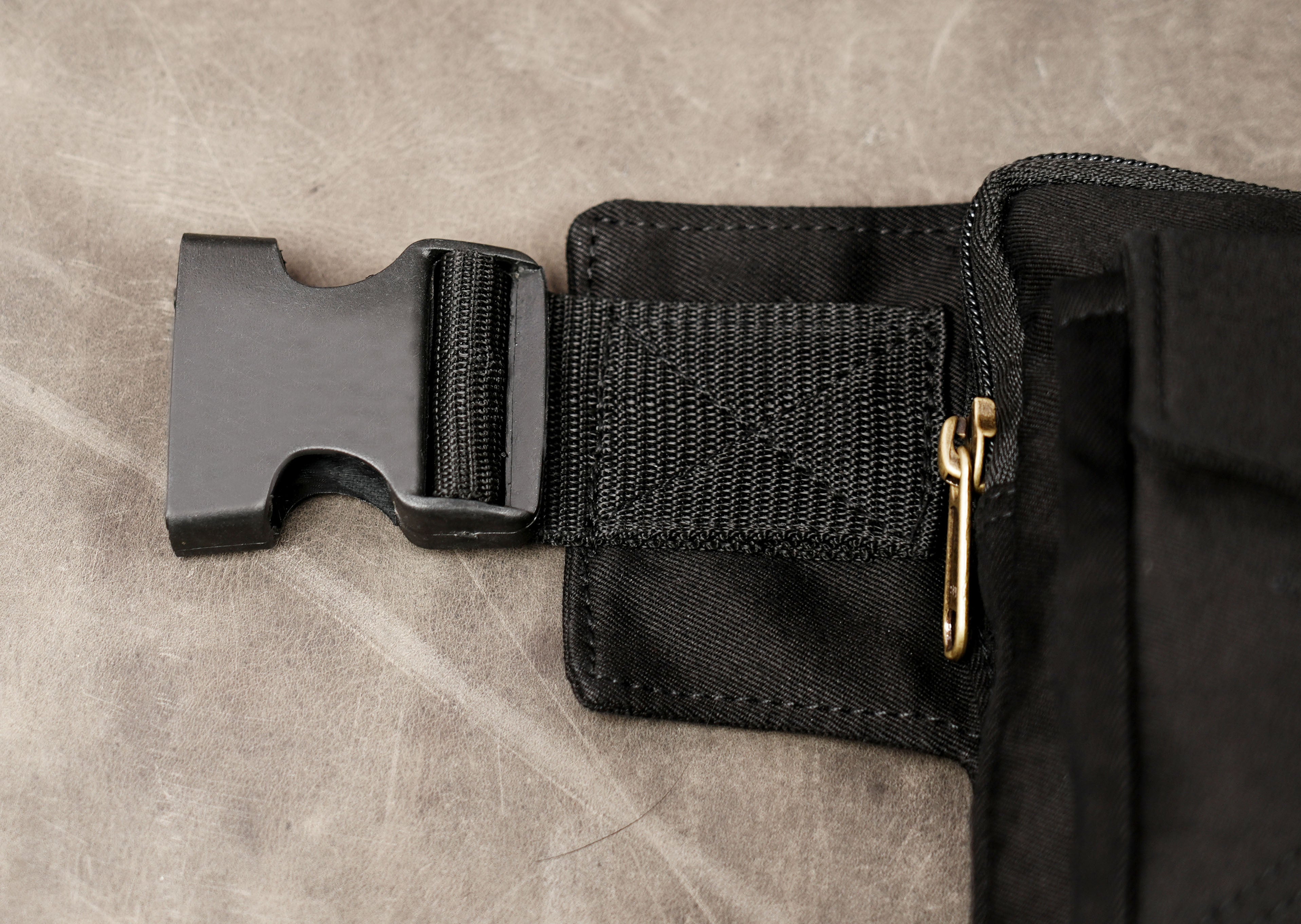 Black utility belt with two flap pockets and brass snap buttons