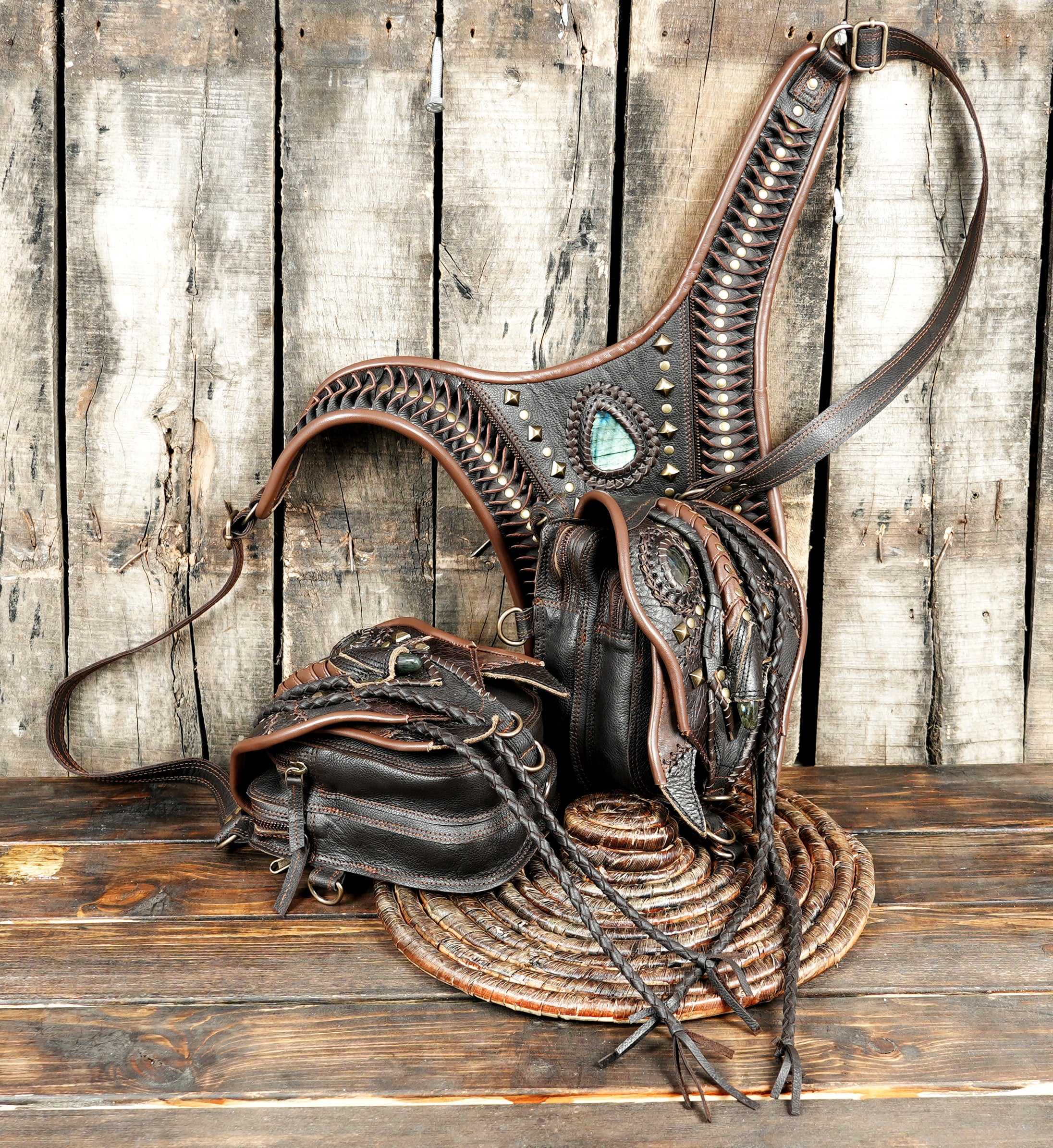 “Premium leather harness holster with braided edges and carved gemstone design”