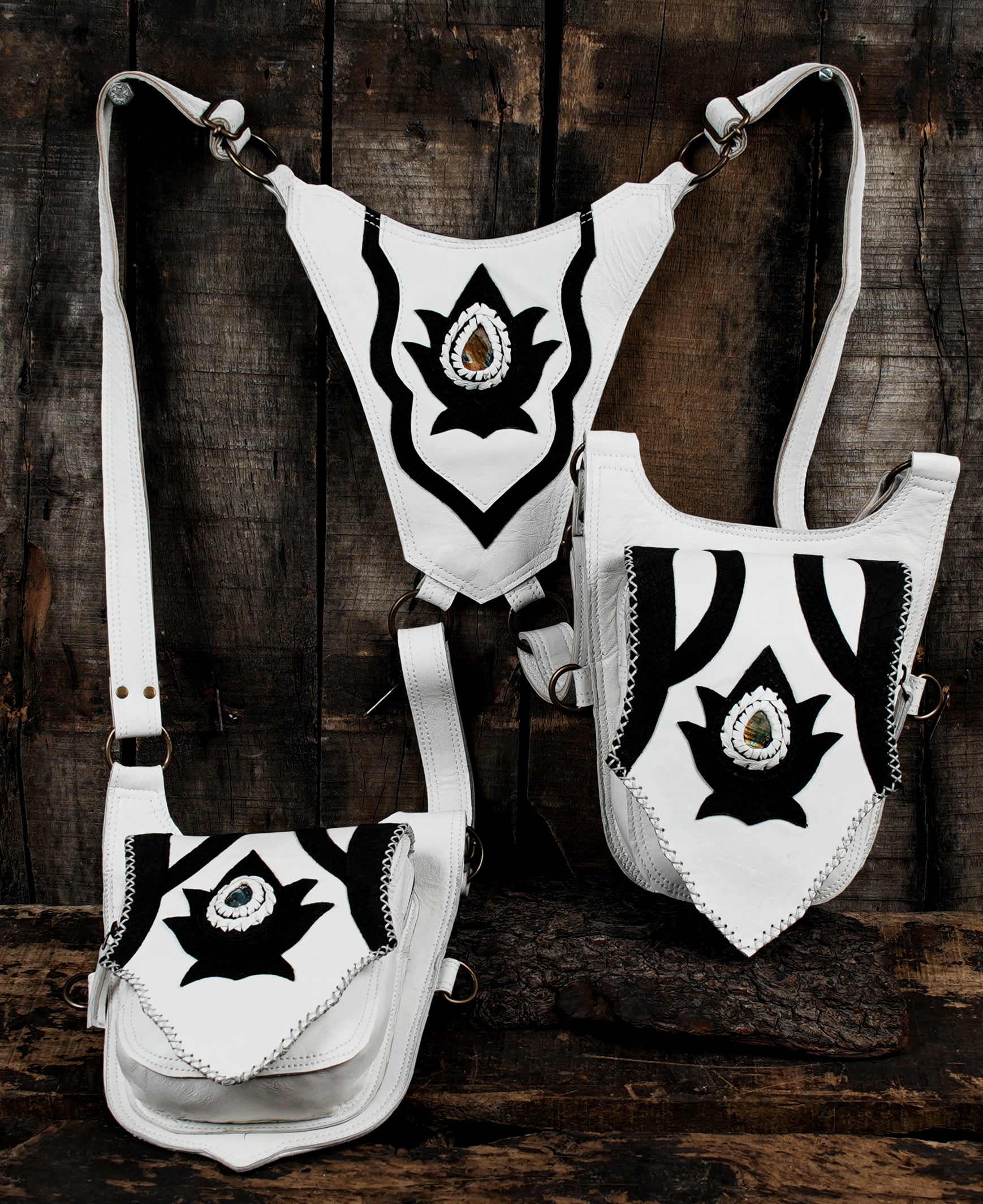 “Artisan leather harness holster with white base and decorative black inlays”