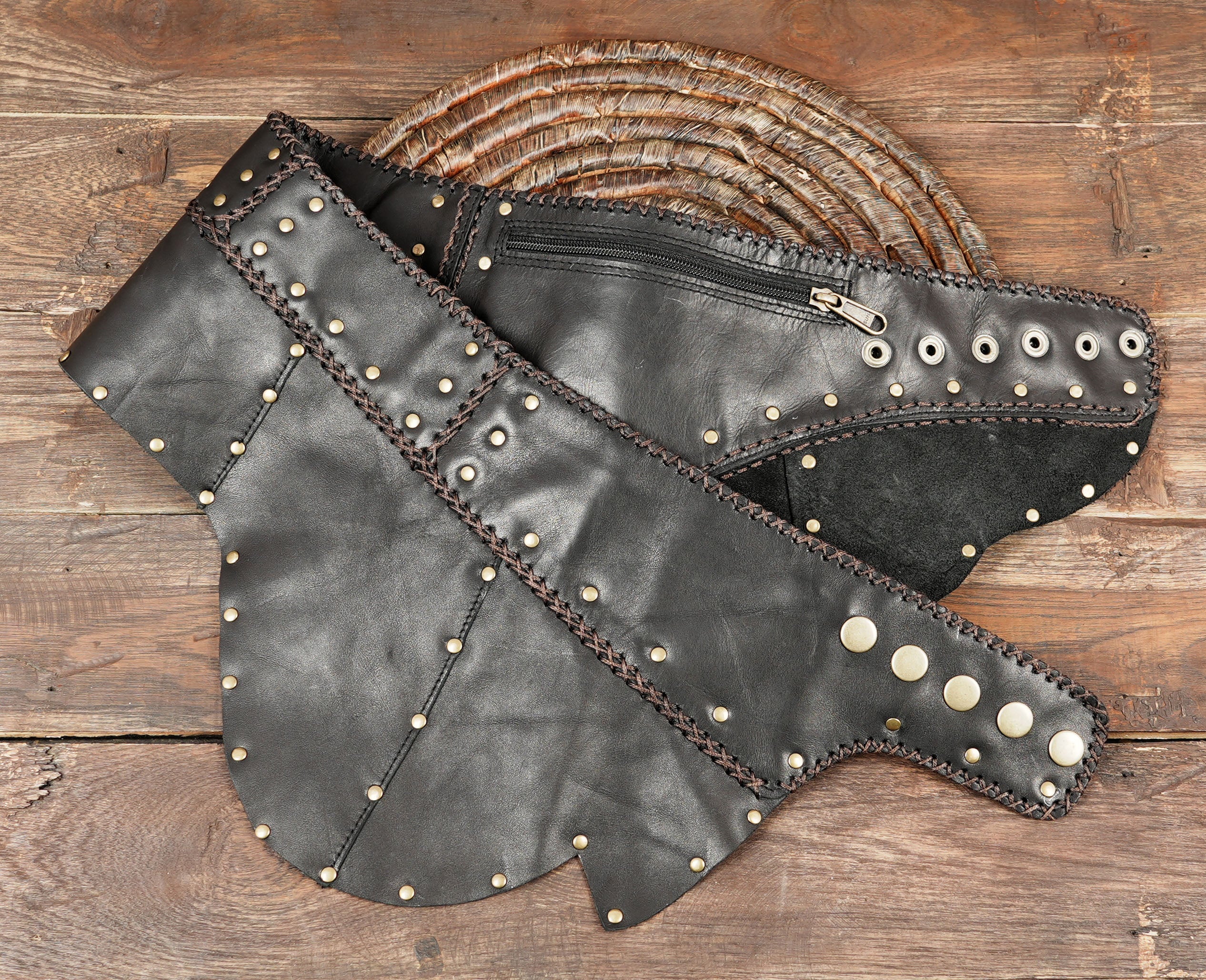 “Festival leather skirt with rivets and cross-stitch accents, tribal boho cosplay clothing.”