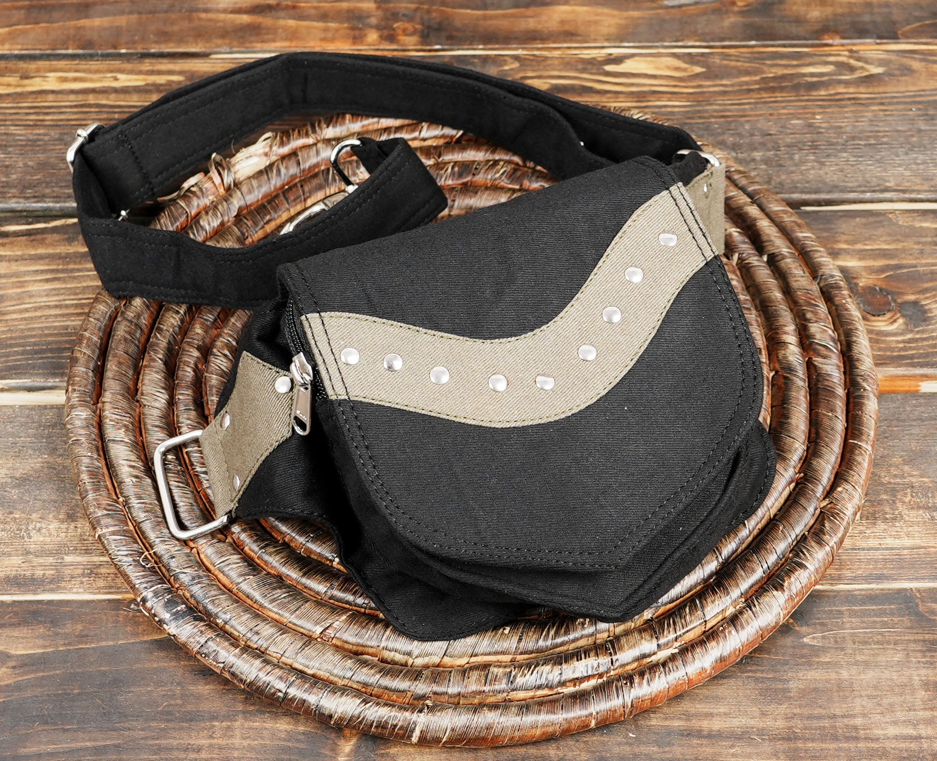 Hands-free convenience with a stylish black canvas waist bag, a popular alternative to bumbags in Europe.