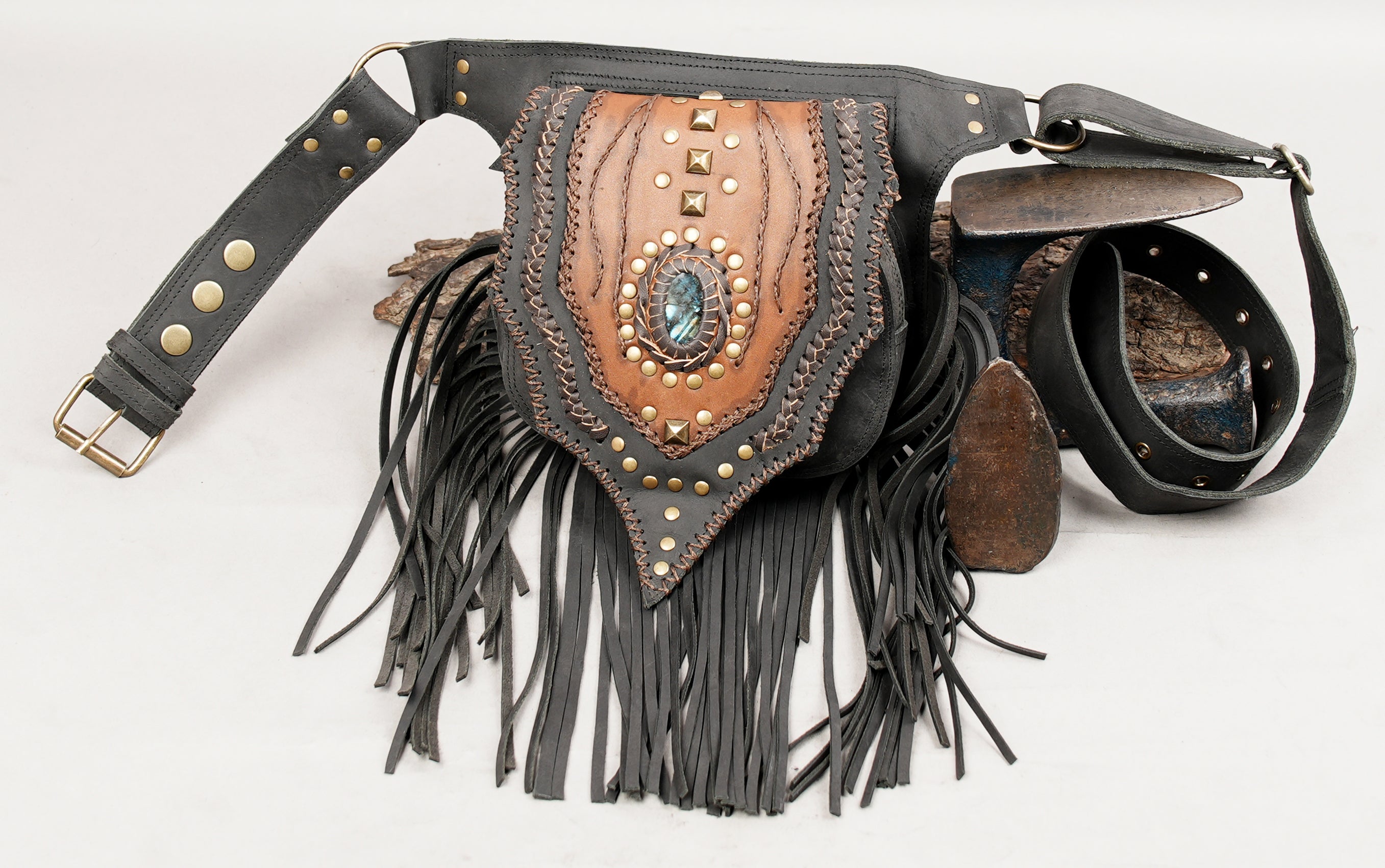 Handmade gemstone leather pouch belt with decorative rivets and fringe.