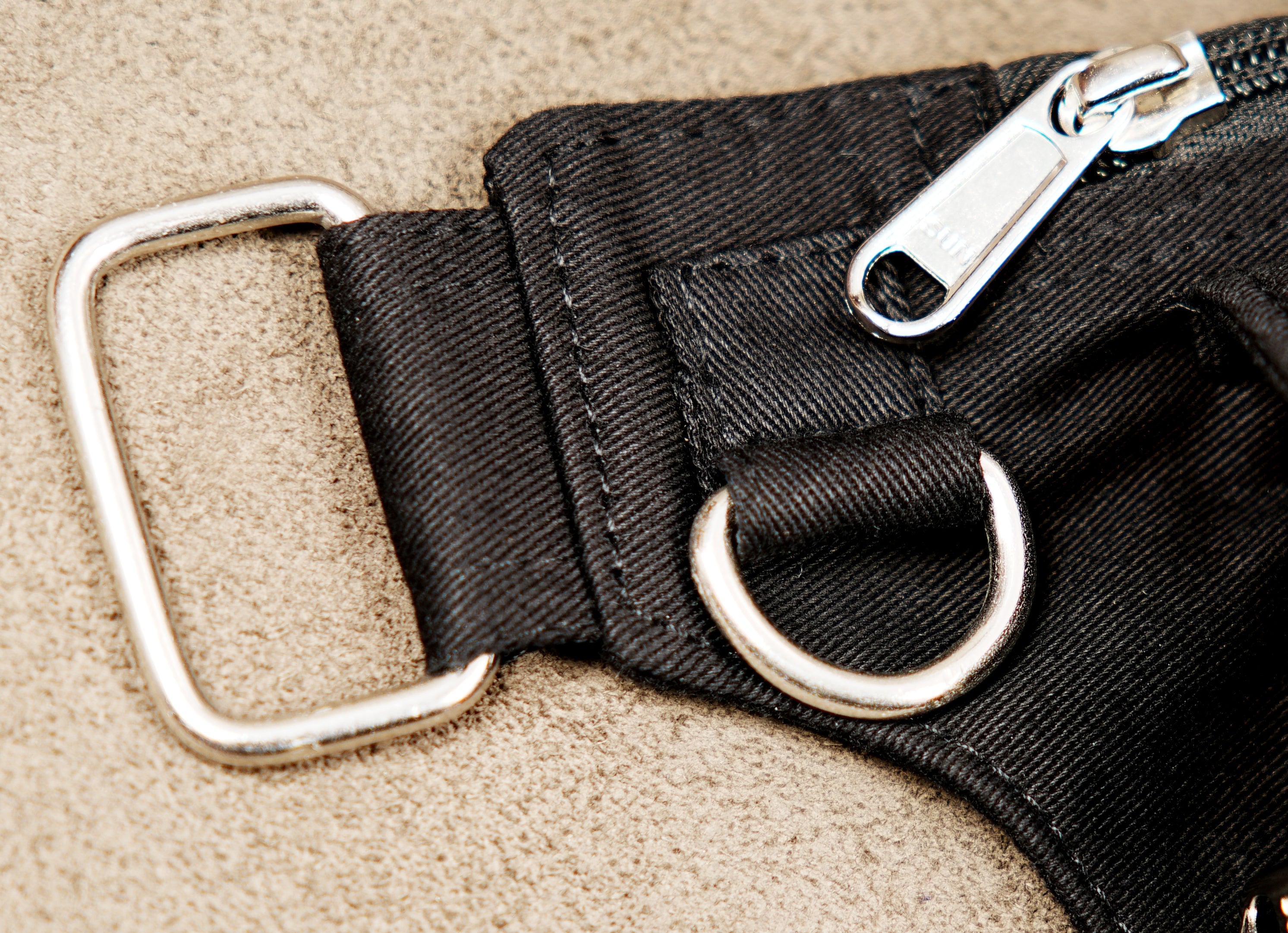 Alternative streetwear belt pouch with silver metal D-rings and zipper closure.