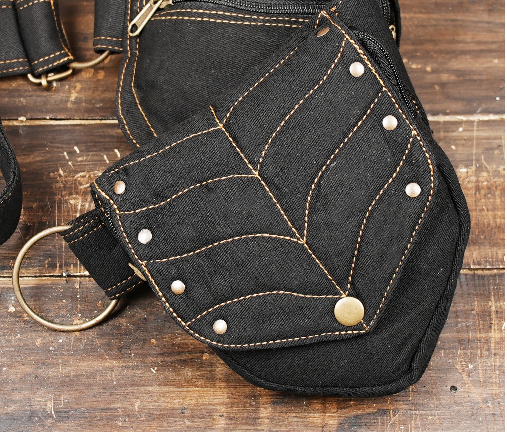 Stylish black bumbag for festivals or travel, with contrasting leaf embroidery on two compartments.