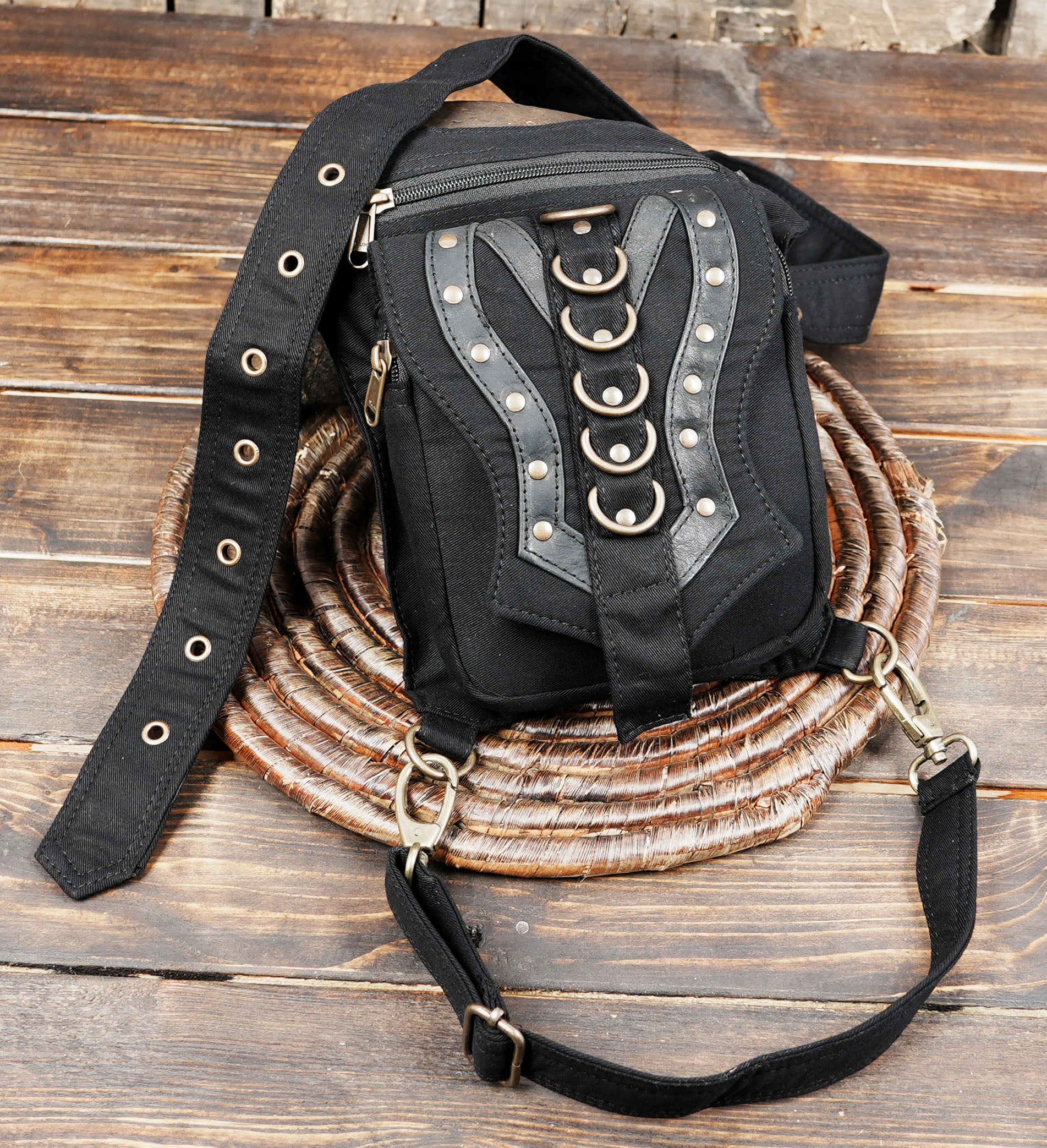 Tribal style canvas side thigh pack with front flap pocket and brass ring trims.