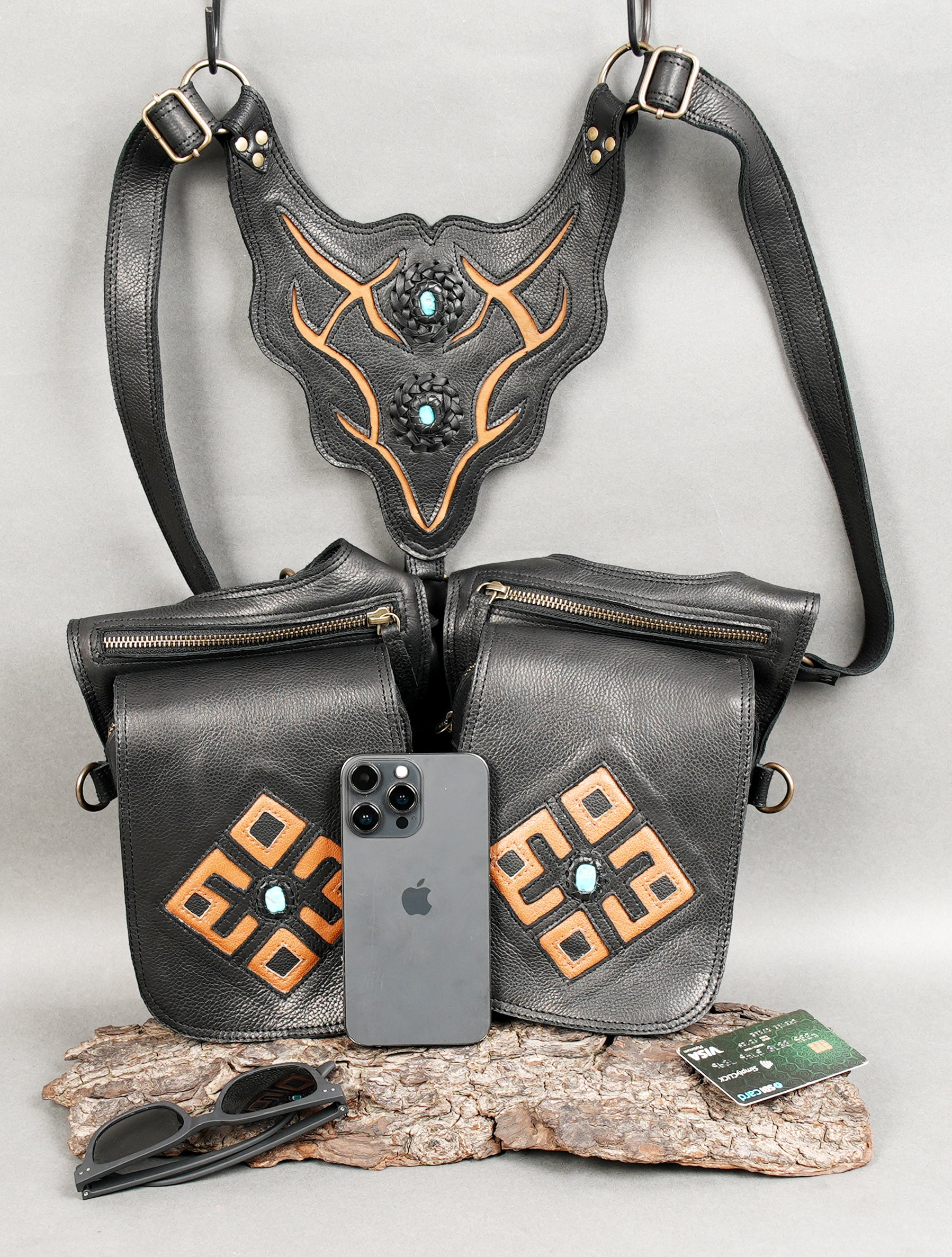 Multifunctional black leather shoulder harness with detachable straps.