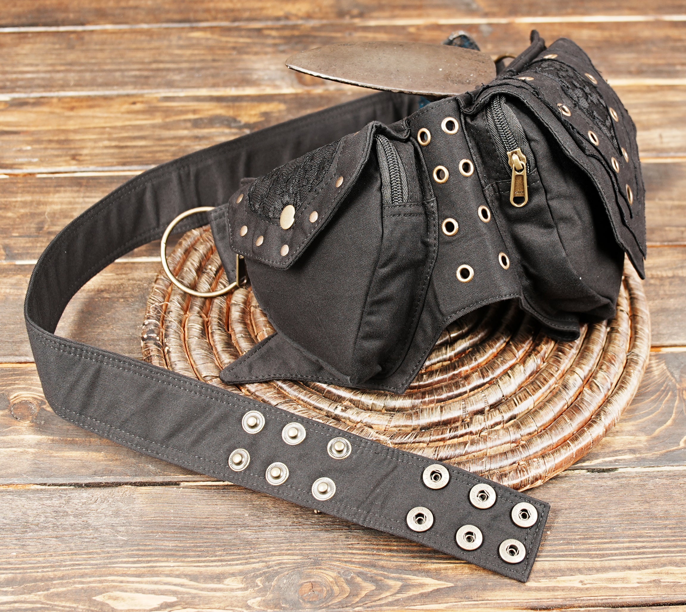 Black utility waist pouch with antique brass studs and eyelet details