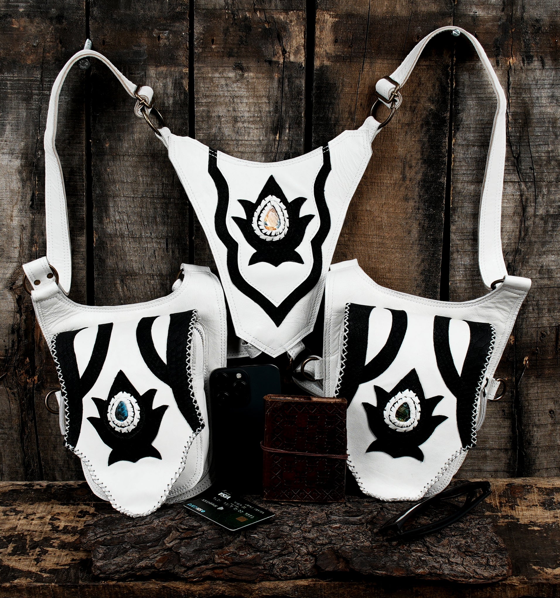 “White leather double pouch holster featuring gemstone centerpiece design”