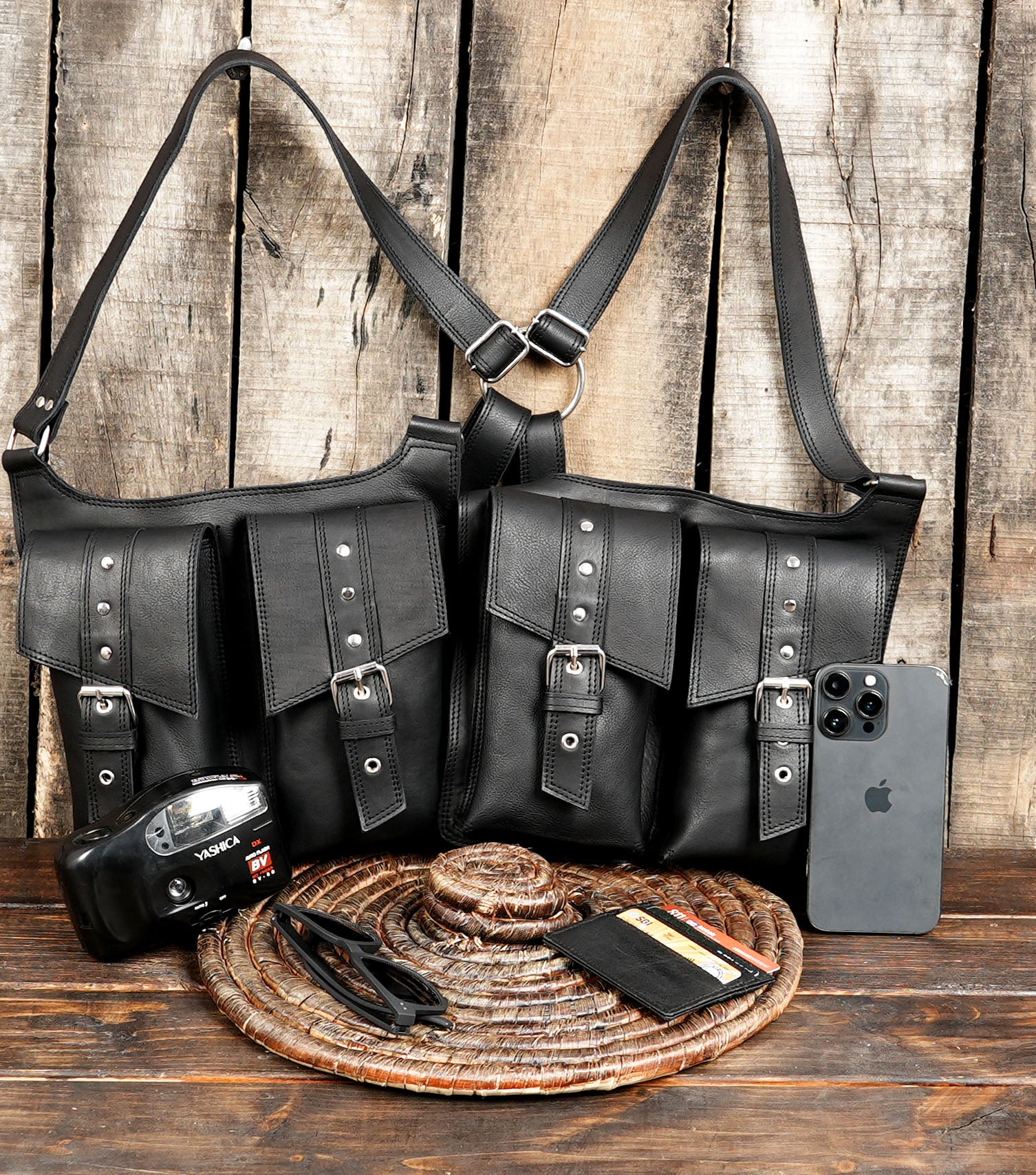 Black leather harness holster with buckle-strap detailing