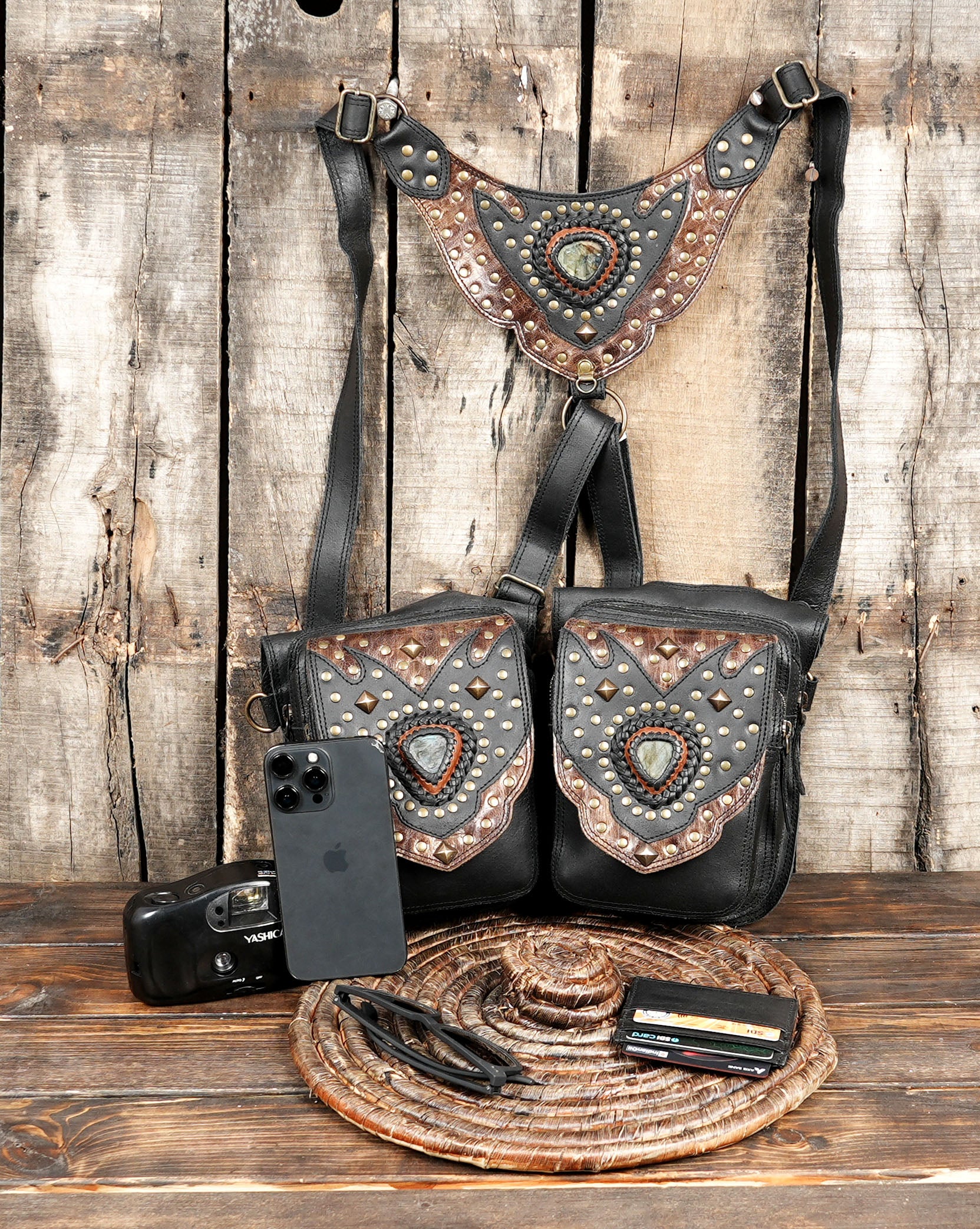 “Handmade leather holster belt with adjustable straps and decorative metal stud patterns”