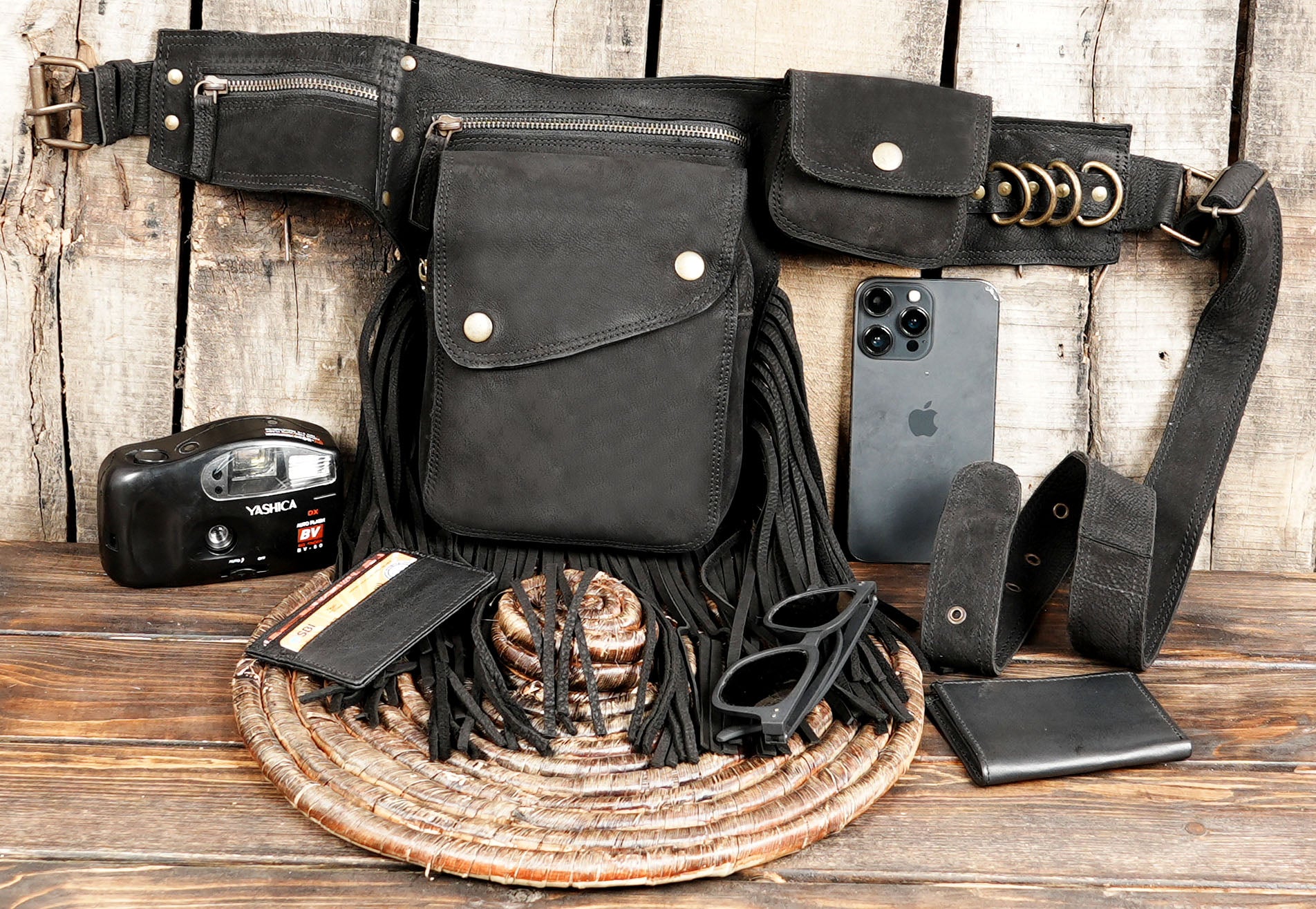Black boho cotton waist bag with long fringes displayed flat