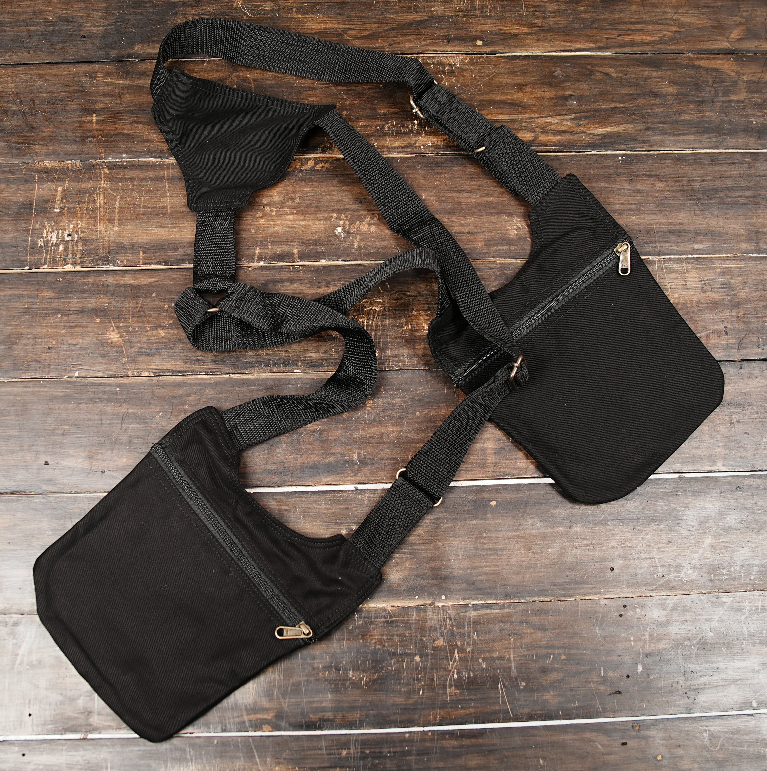 Black utility body bag with zippered pockets and adjustable straps