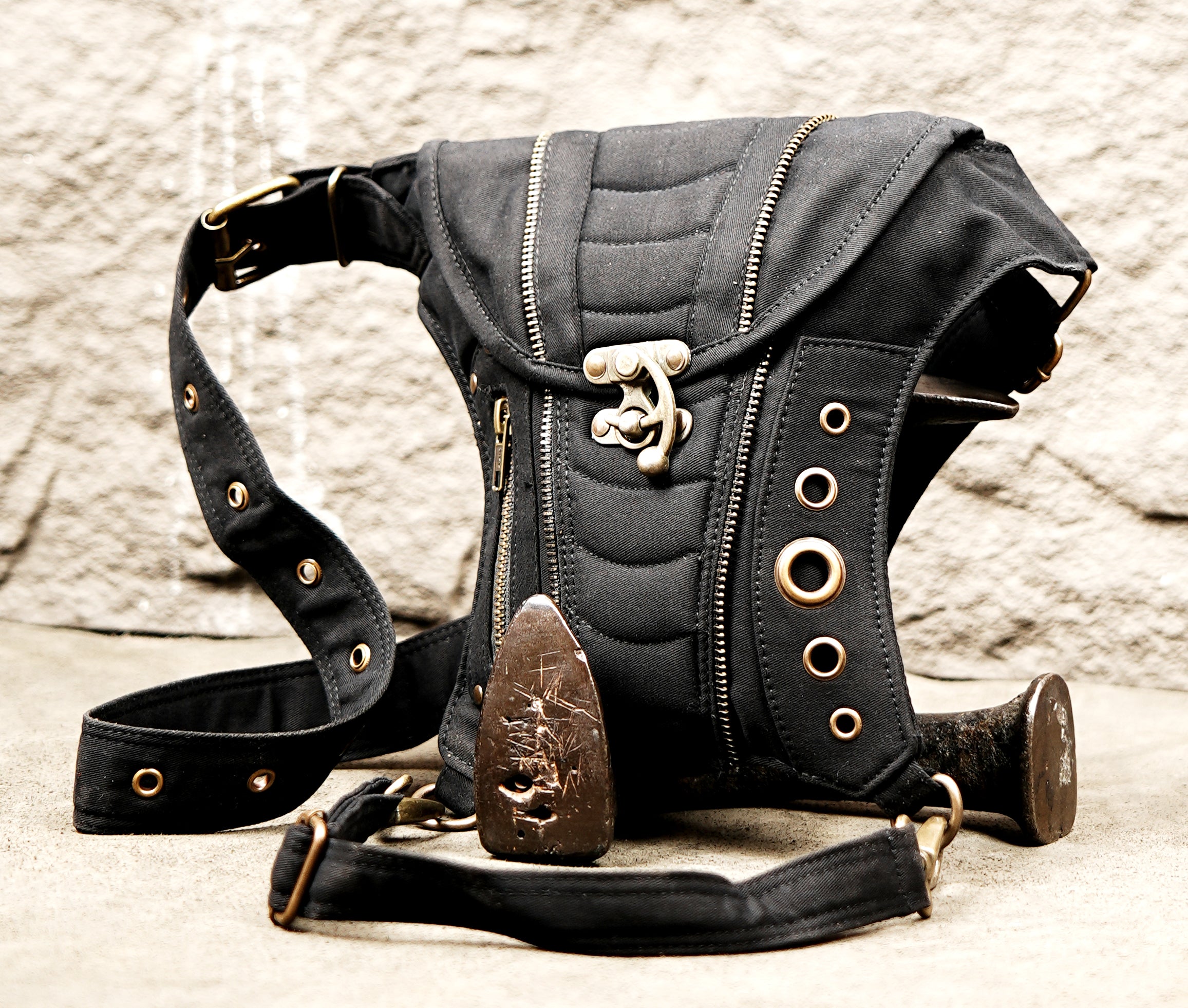 Alternative streetwear side pouch bag in canvas with brass ring detailing.