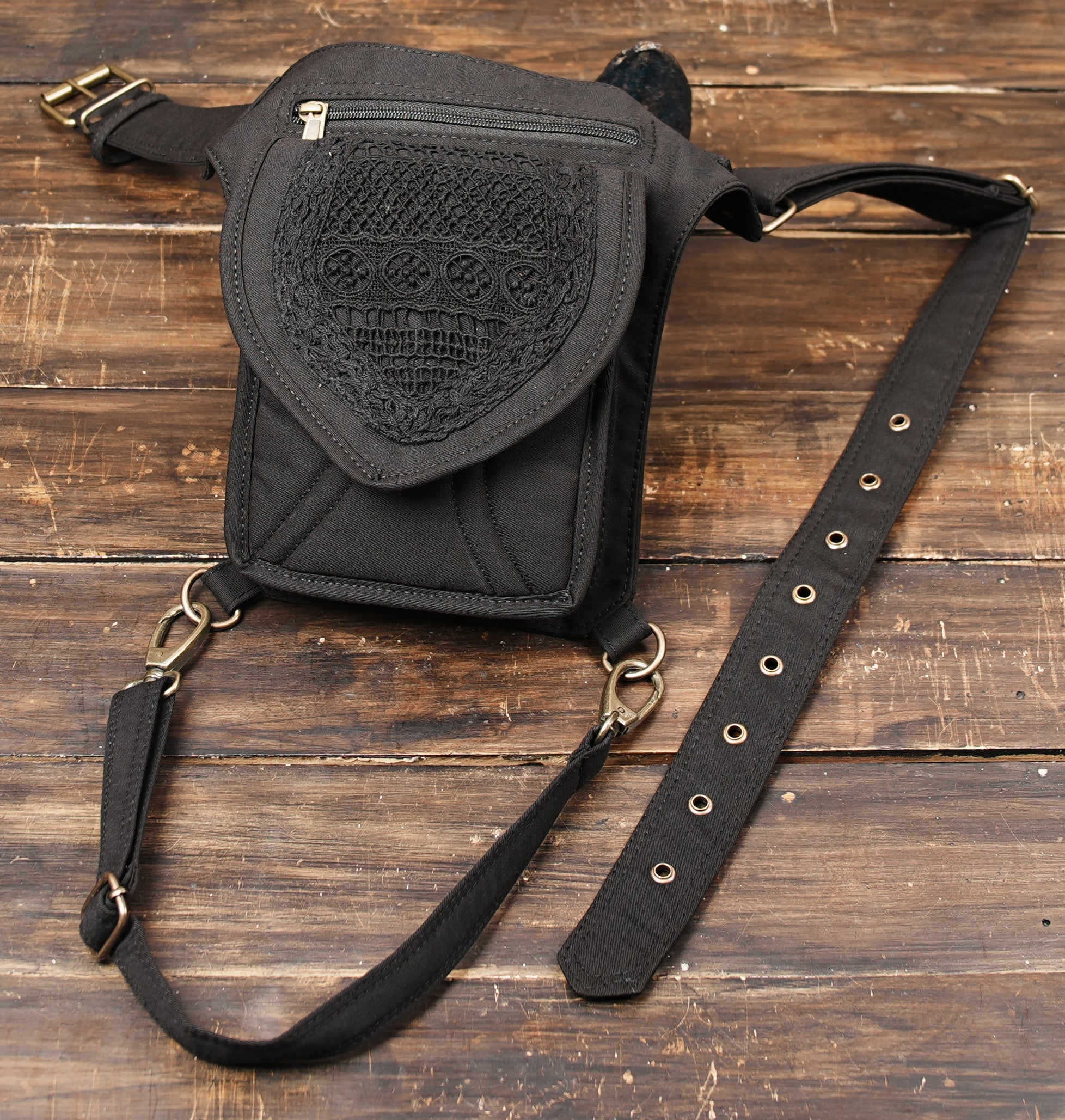 Hands-free festival utility hip pouch with adjustable eyelet waist belt and leg fastener.
