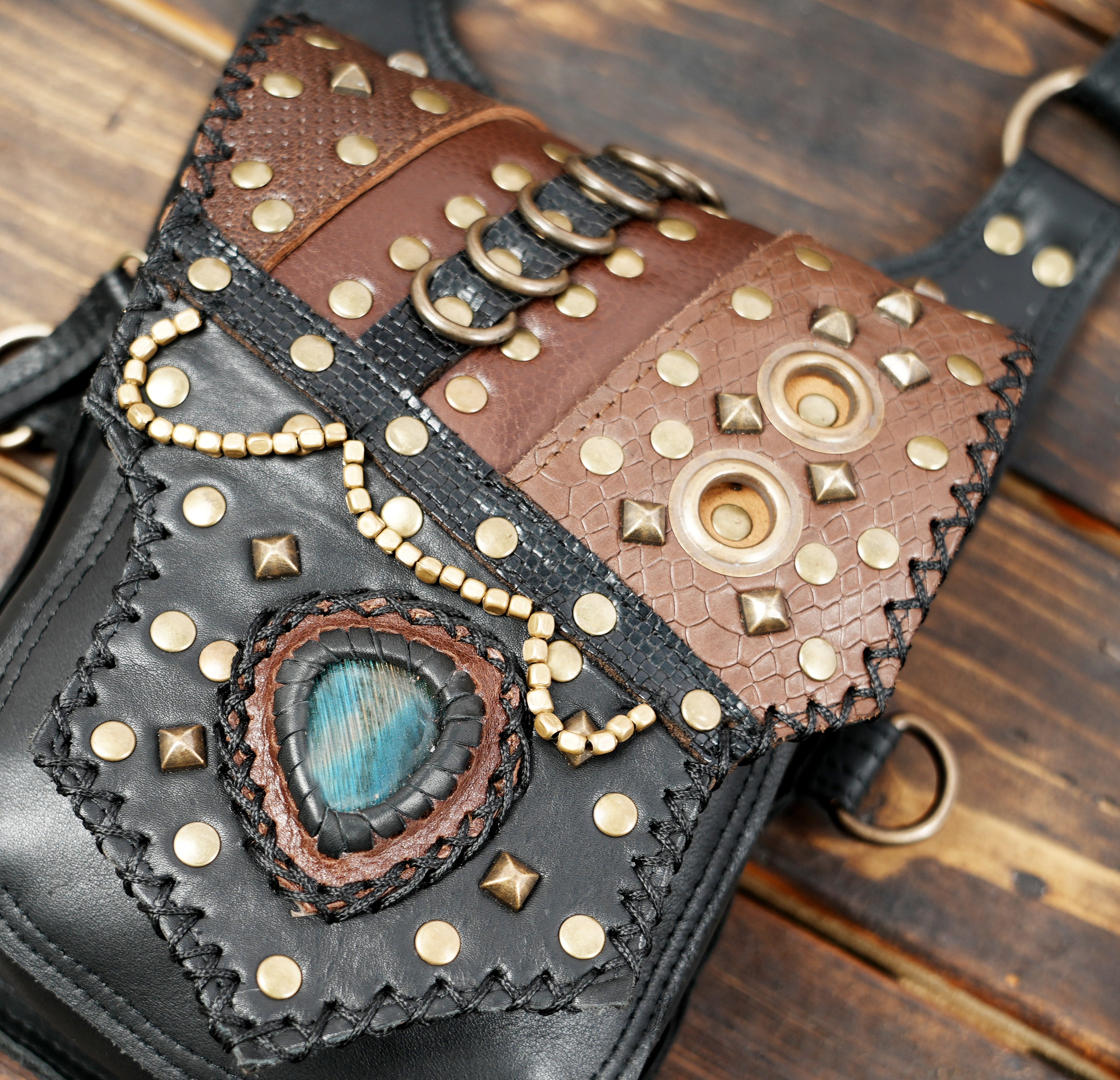 Crafted leather harness holster with metal rivets and beads