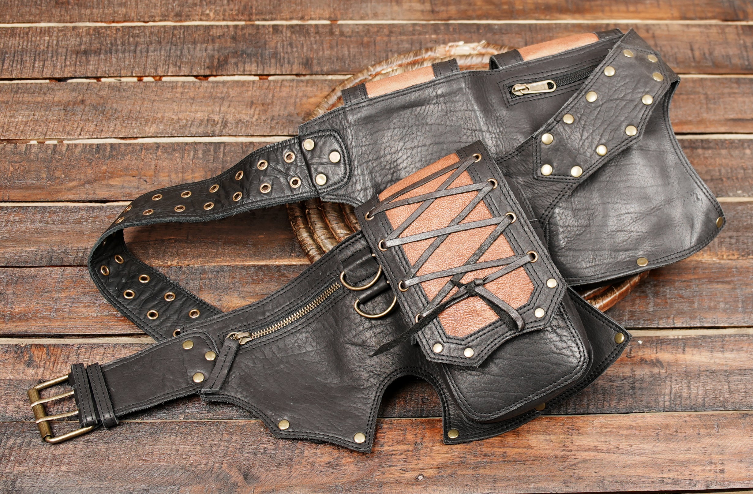 Crafted from premium black and brown leather, it features lace-up detailing, rivet accents, and multiple pouches, making it ideal for carrying essentials like your phone, wallet, or keys while keeping your hands free.