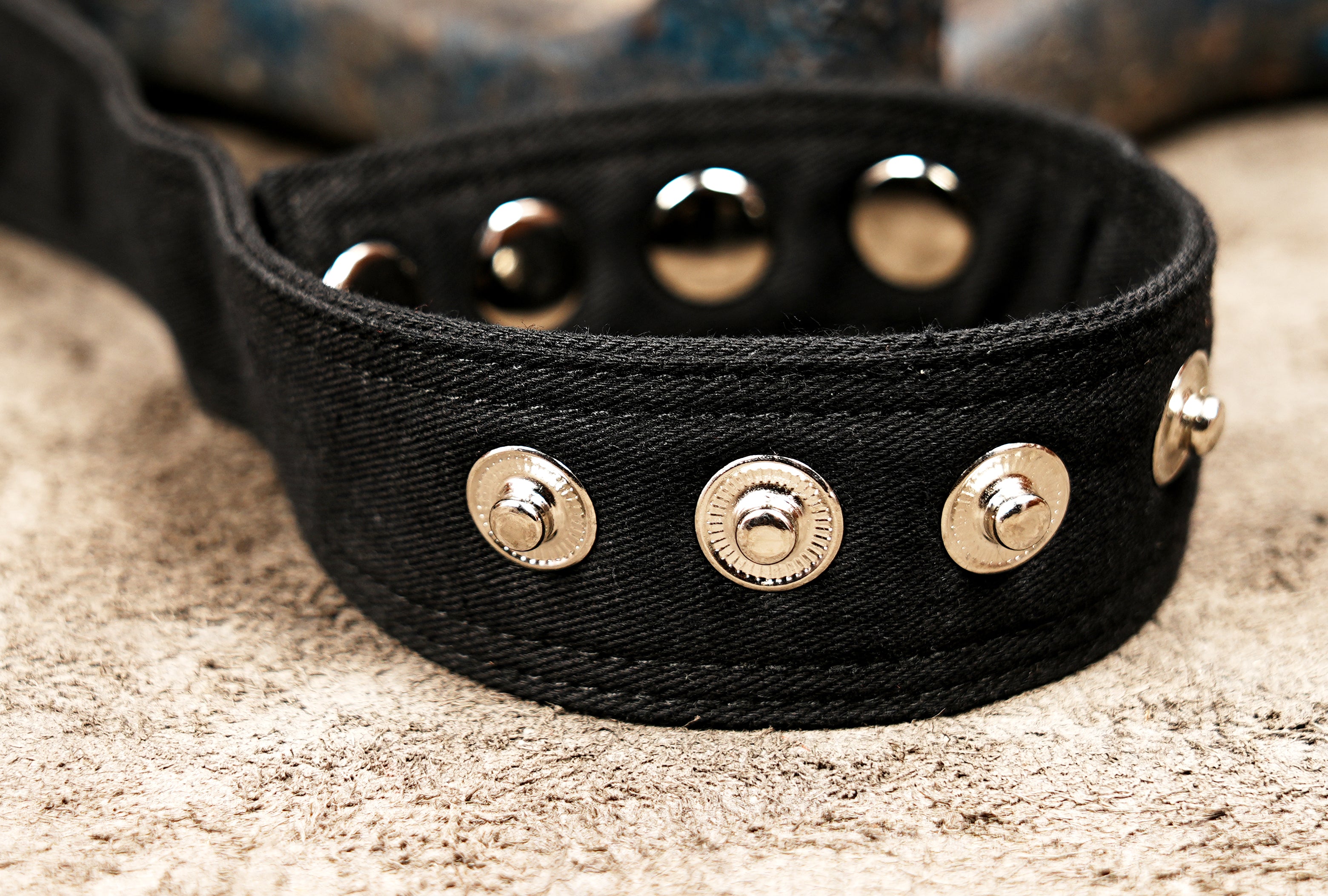 Rugged cotton thigh bag showcasing silver hardware and stud detailing