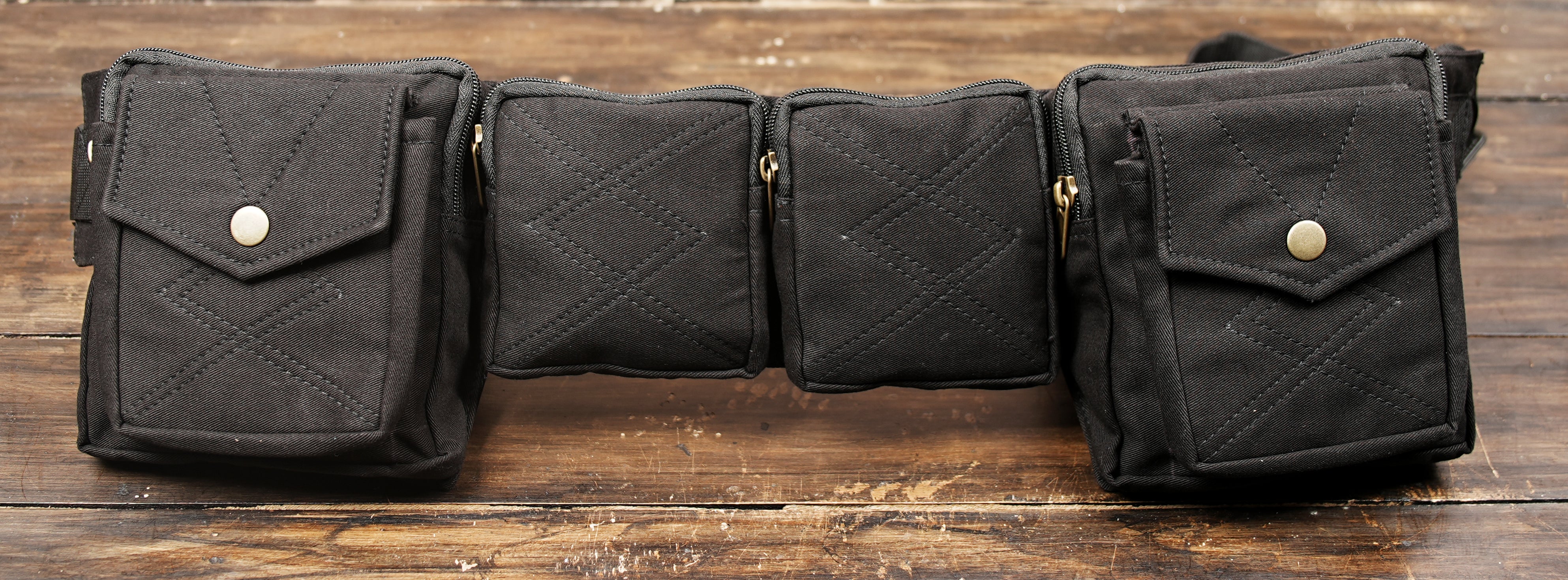 Black cotton utility belt bag with multiple storage pockets for festivals and travel