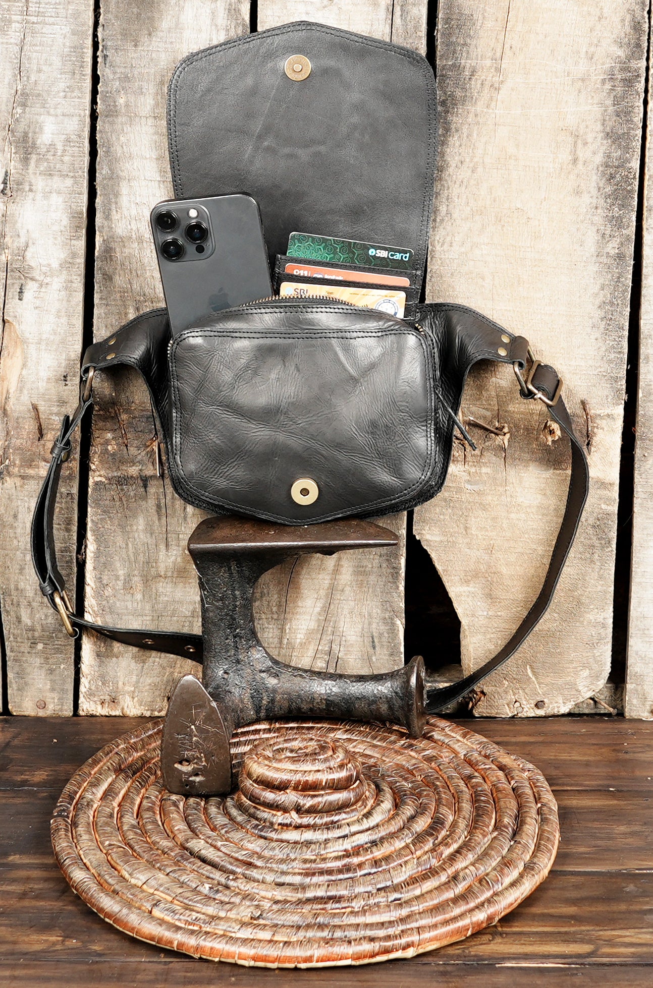 Adjustable leather hip bag with decorative gemstone on flap