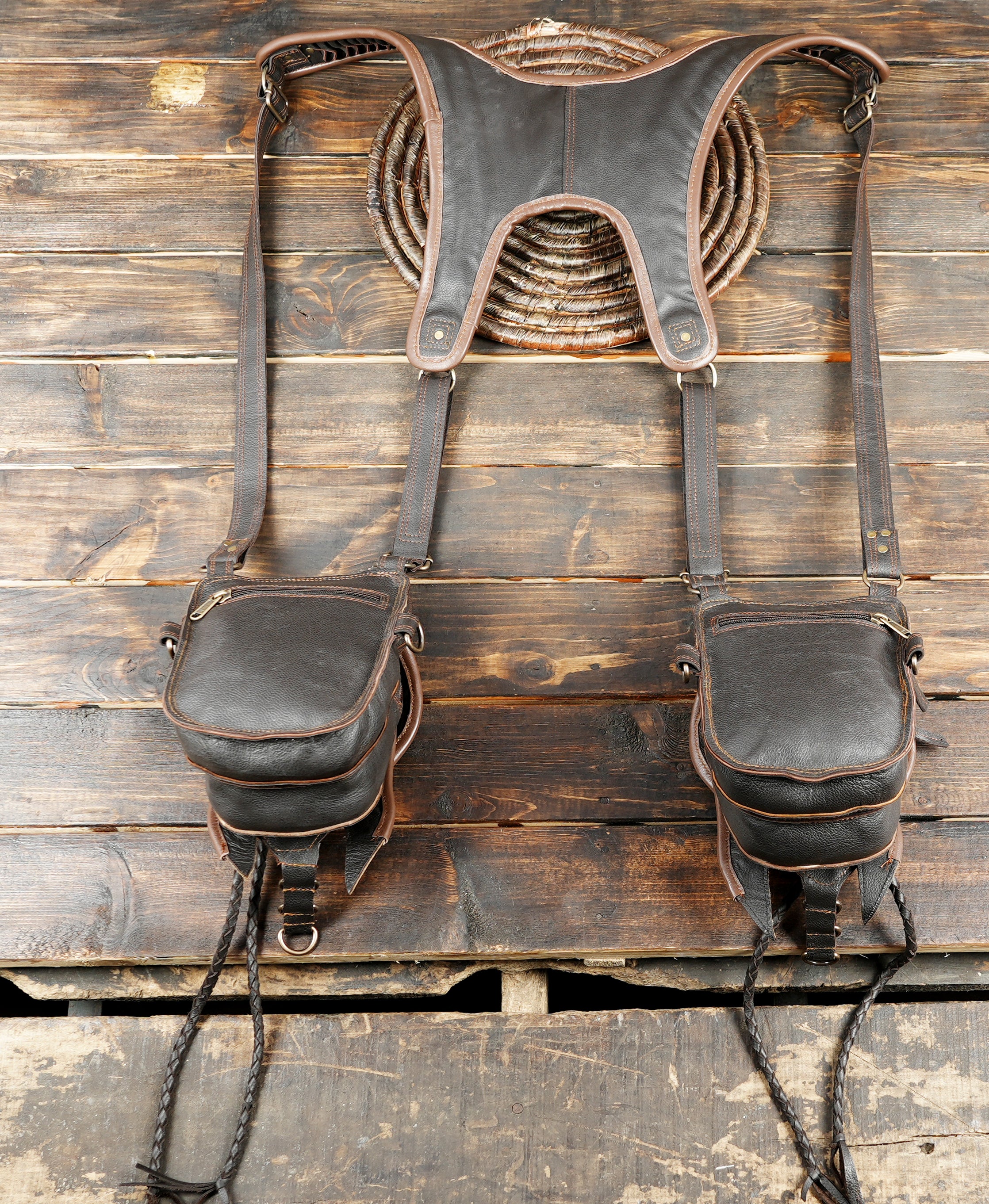 “Steampunk-style leather holster with tassels, tribal artwork, and dual pockets”