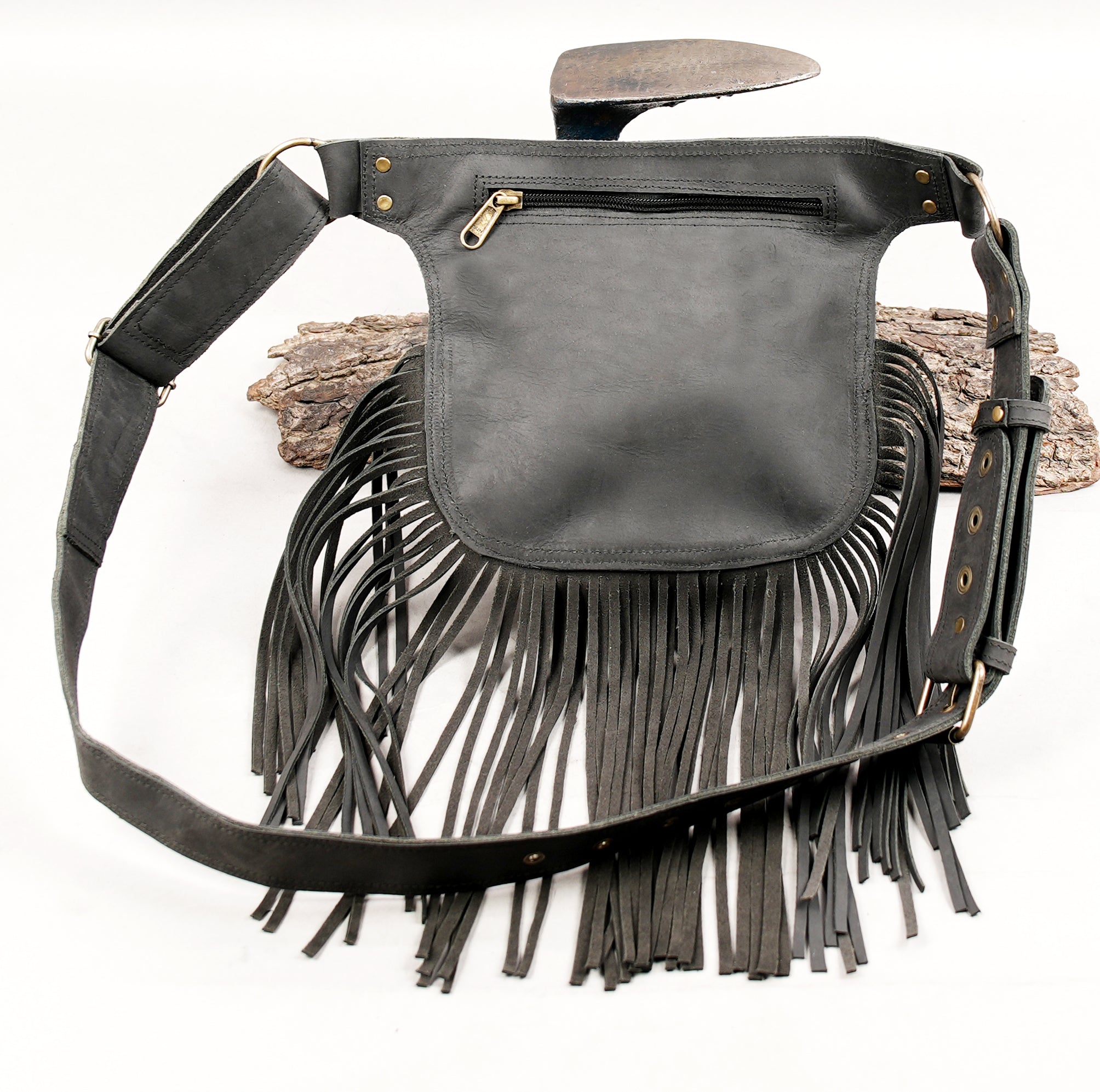 Fringe leather utility belt with gemstone and adjustable strap.