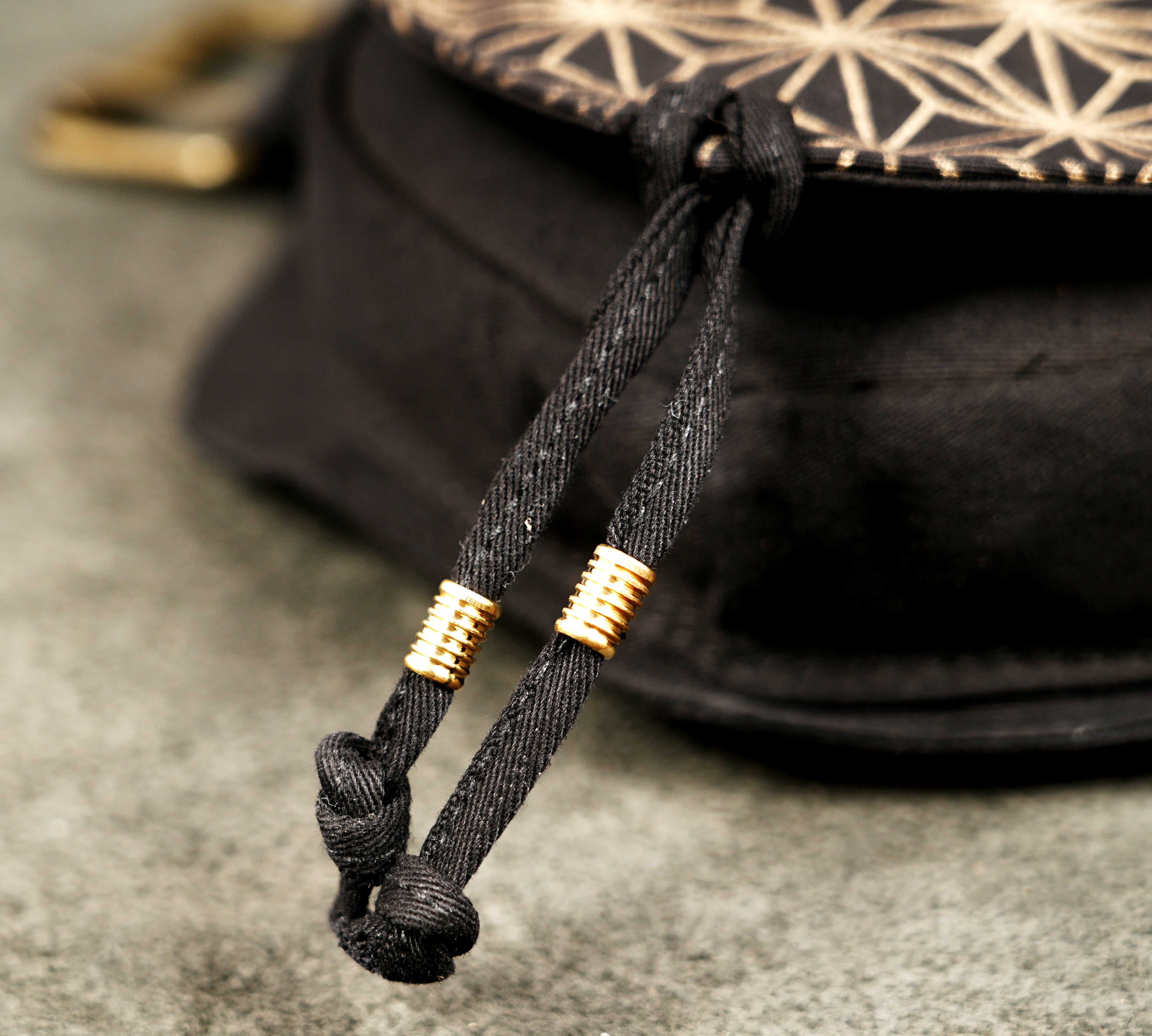 Adjustable canvas belt bag with brass grommets, worn around the waist