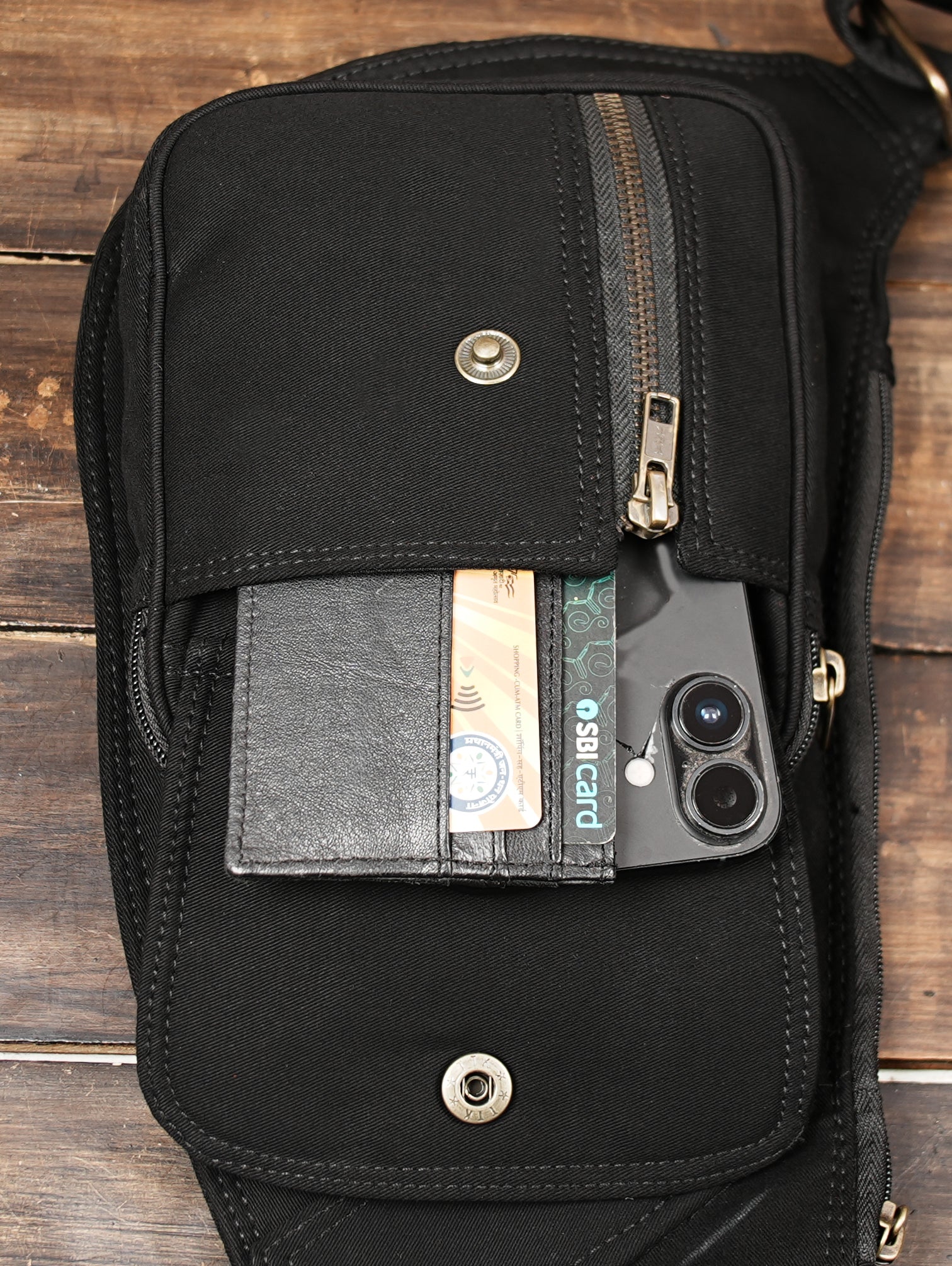 Rugged canvas utility sling bag showcasing front pockets and secure snap closures