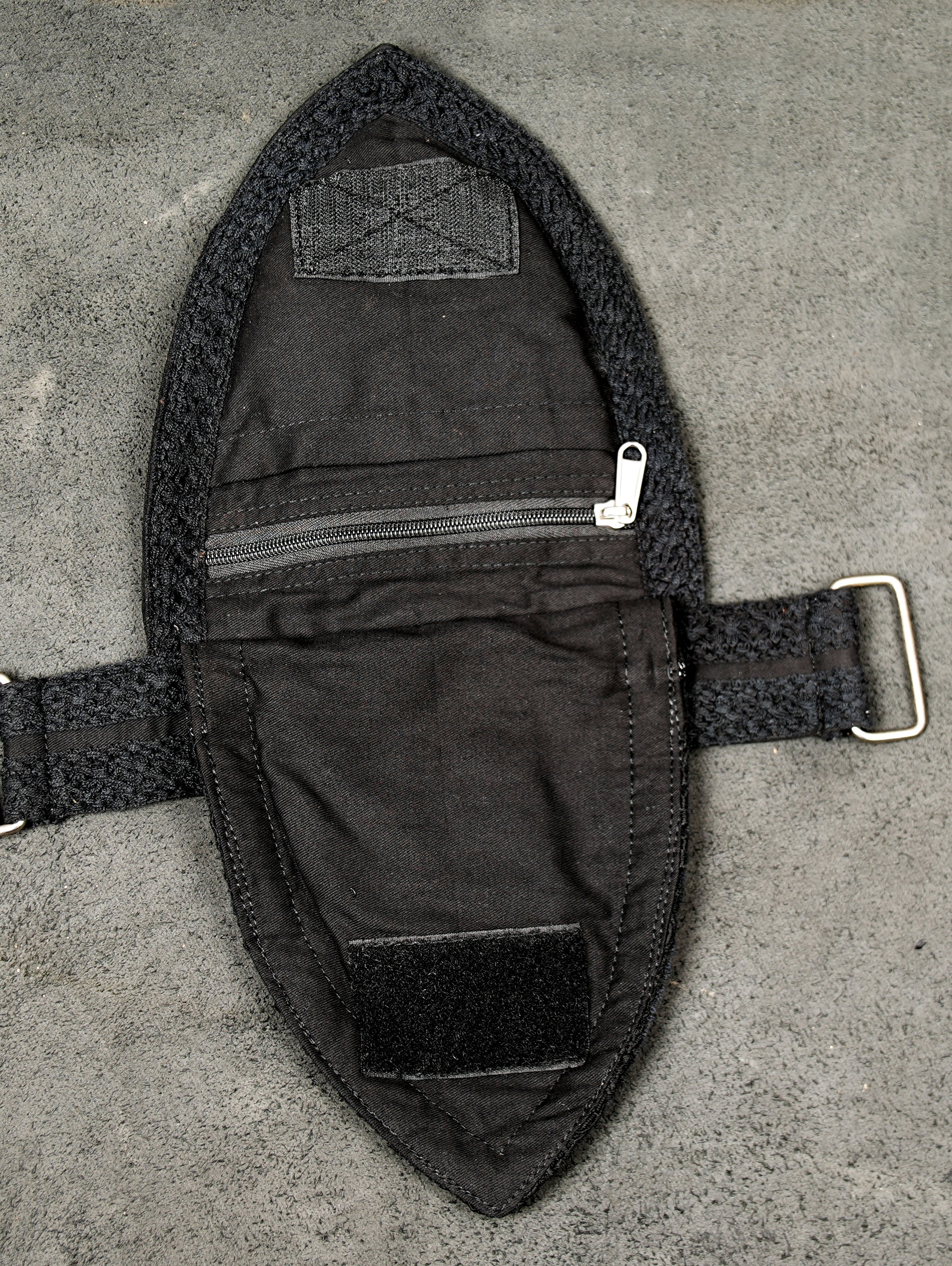 Black boho hip bag with lace texture detail and grommet belt strap