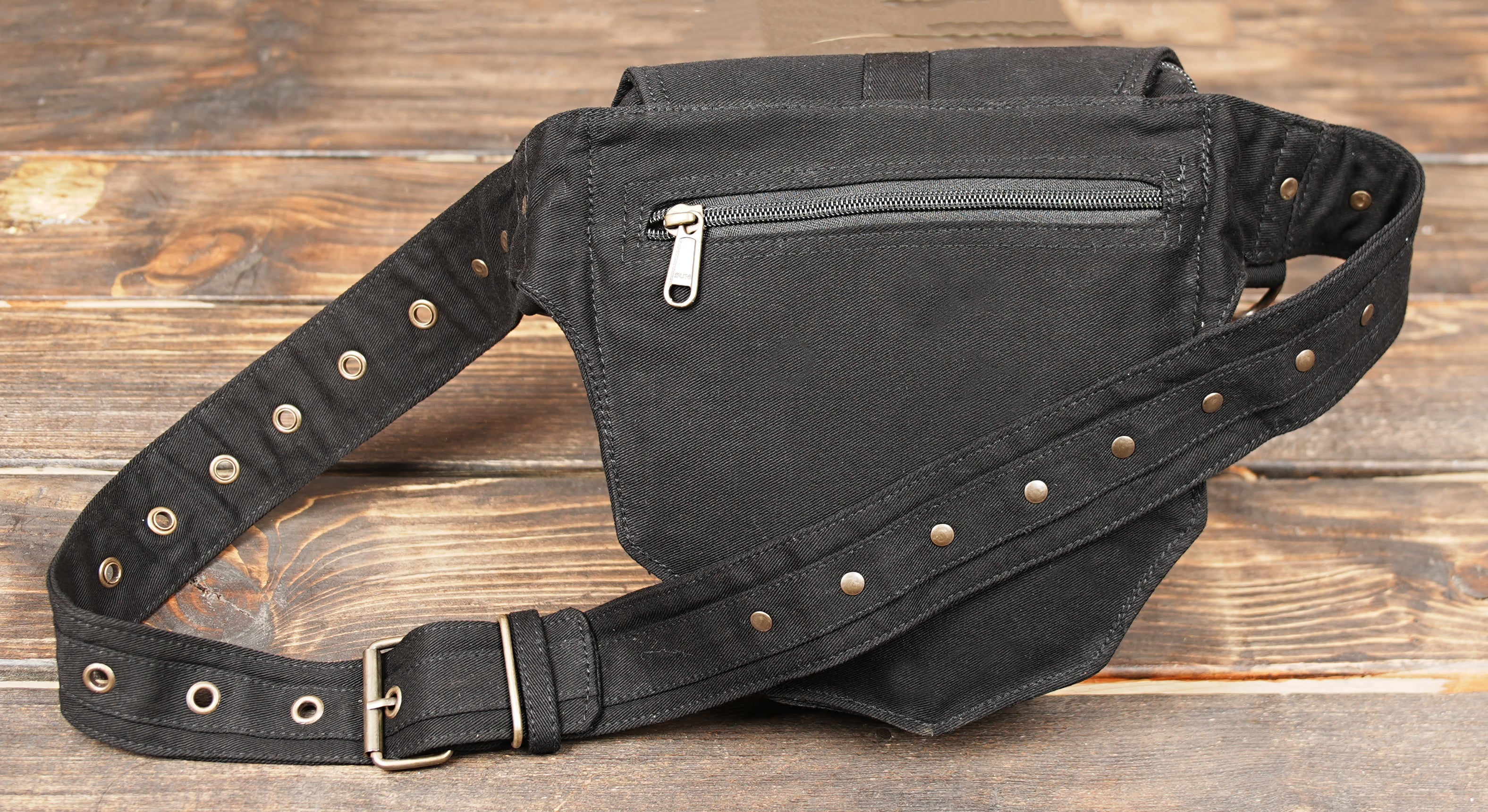 Black utility hip bag with riveted flap and wide strap