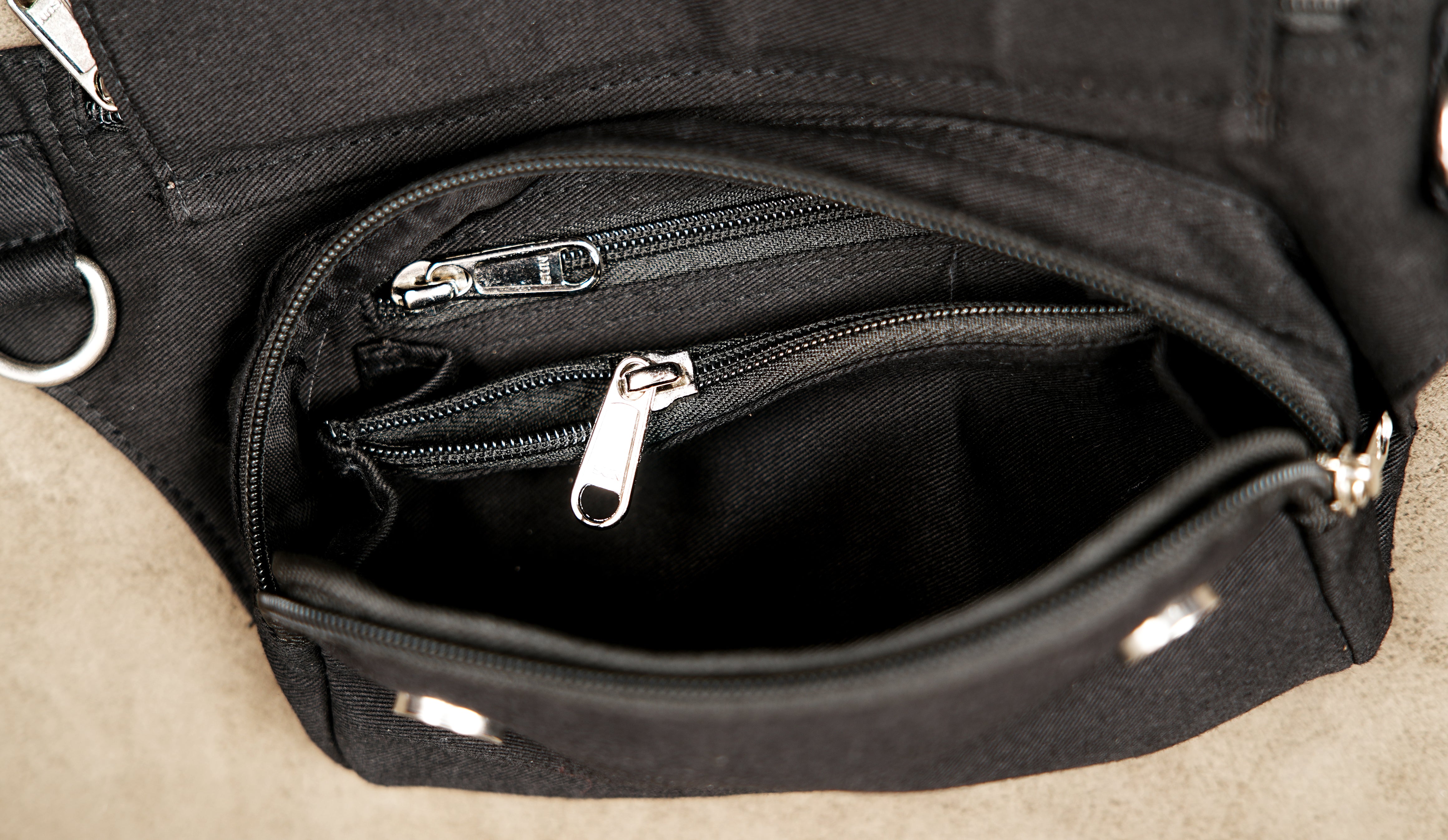 Black canvas hip belt bag designed for hands-free convenience at music festivals.