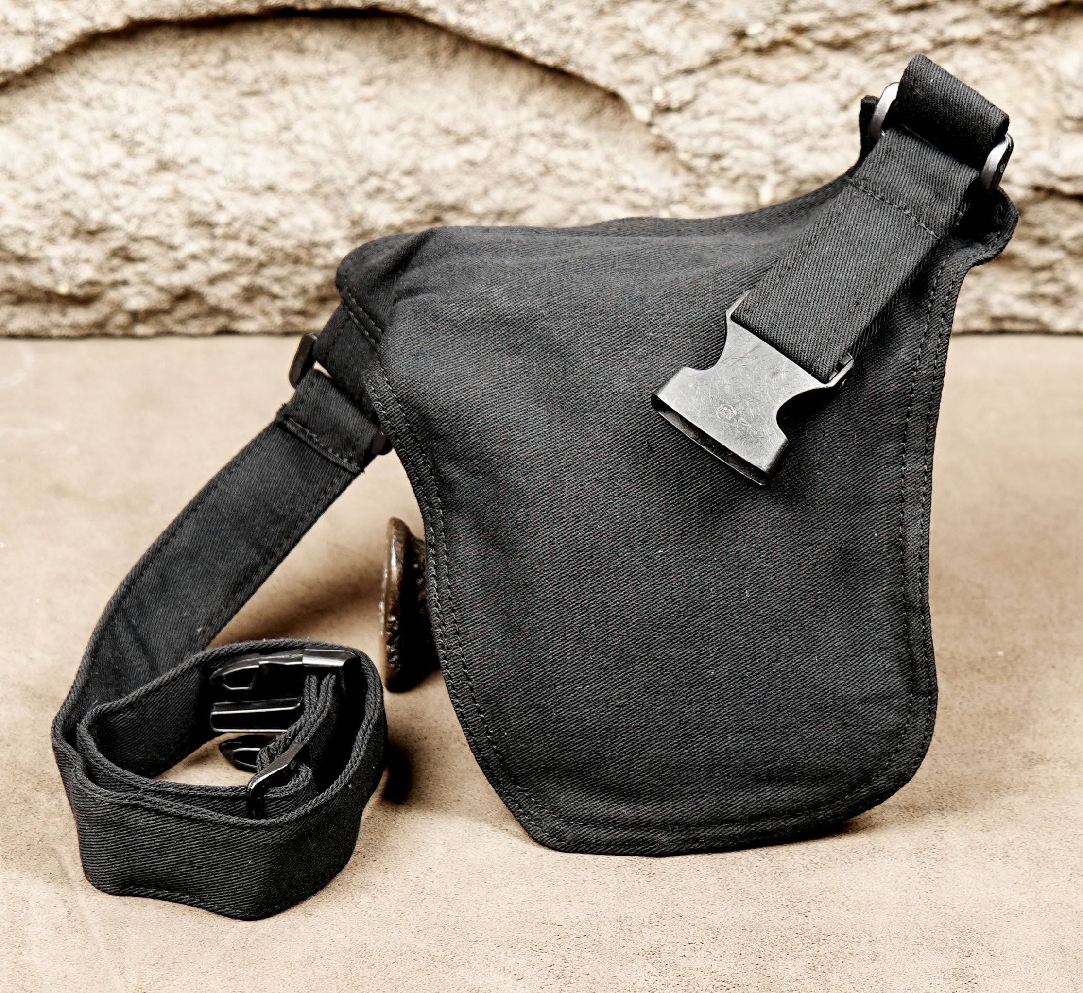 Unisex cotton hip bag laid out on leather background