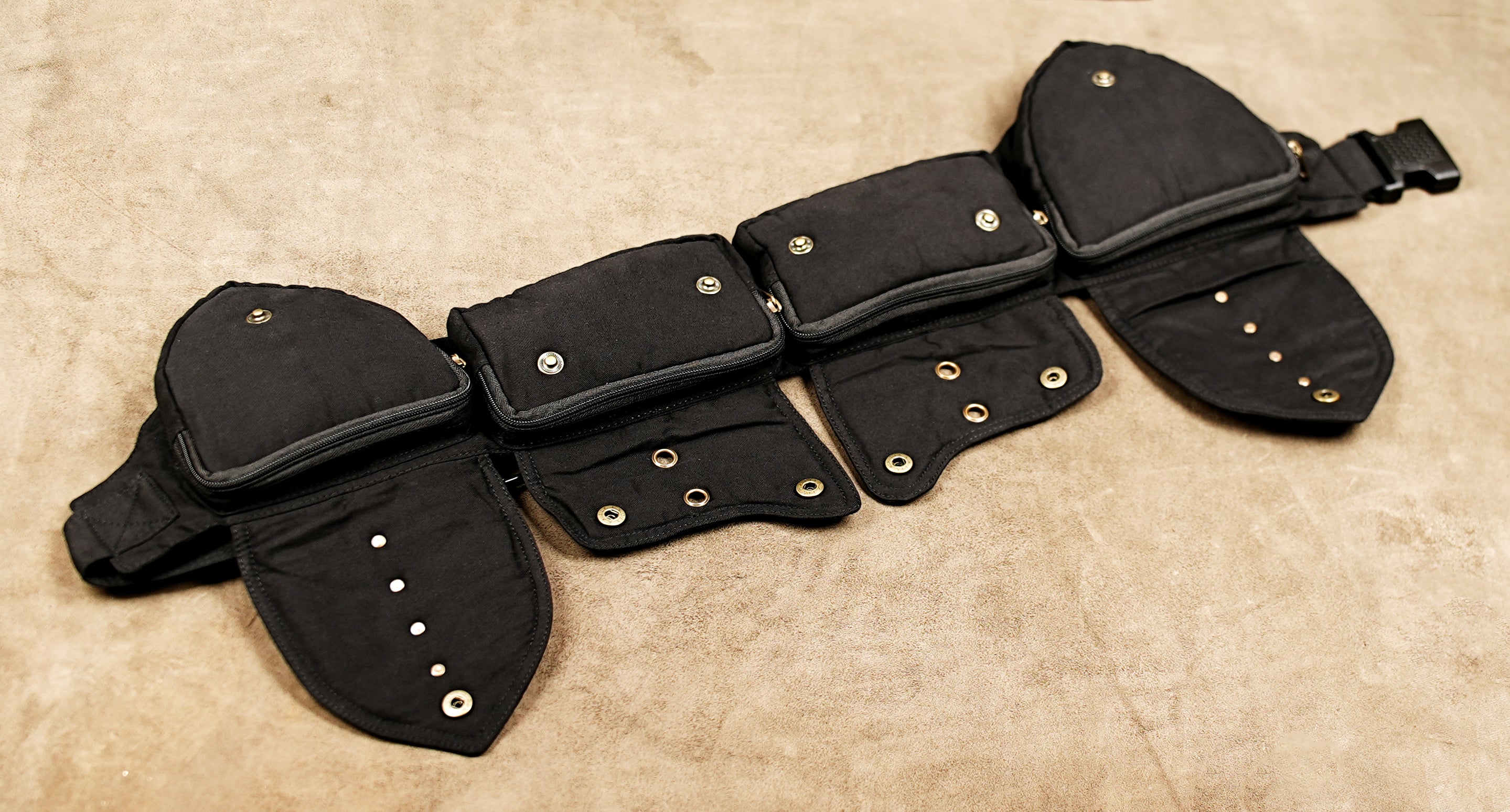 Black cotton utility waist thigh strap belt with four pockets and brass studs, top view