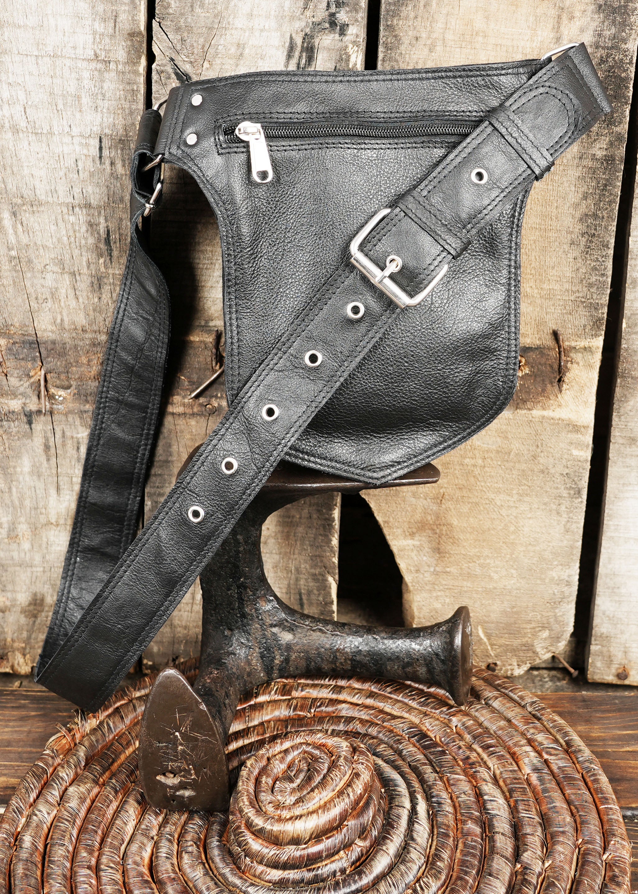 Detailed close-up of gemstone and braided leather on Western belt bag