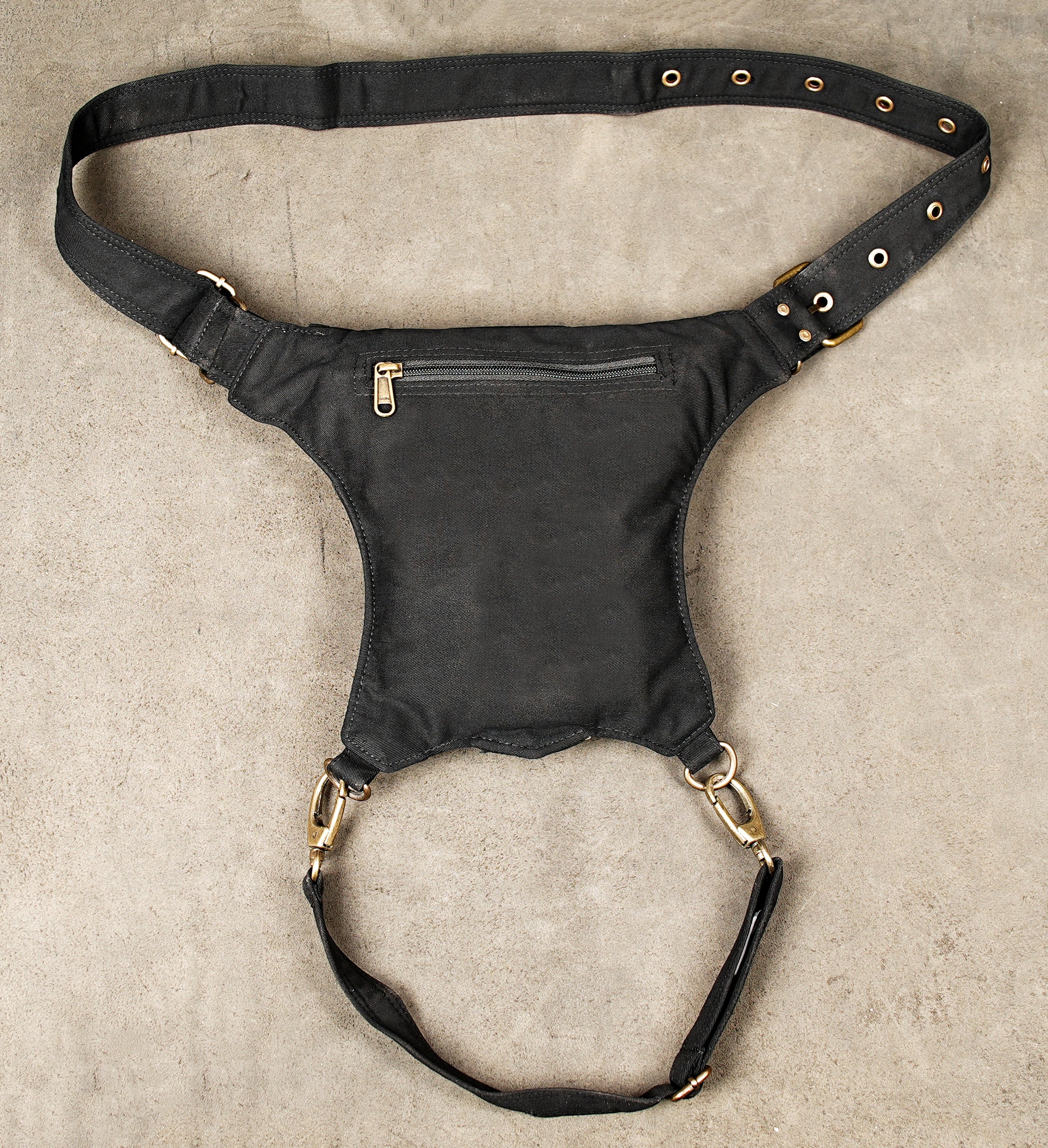 Functional canvas leg bag with heavy-duty metal clips and adjustable straps.