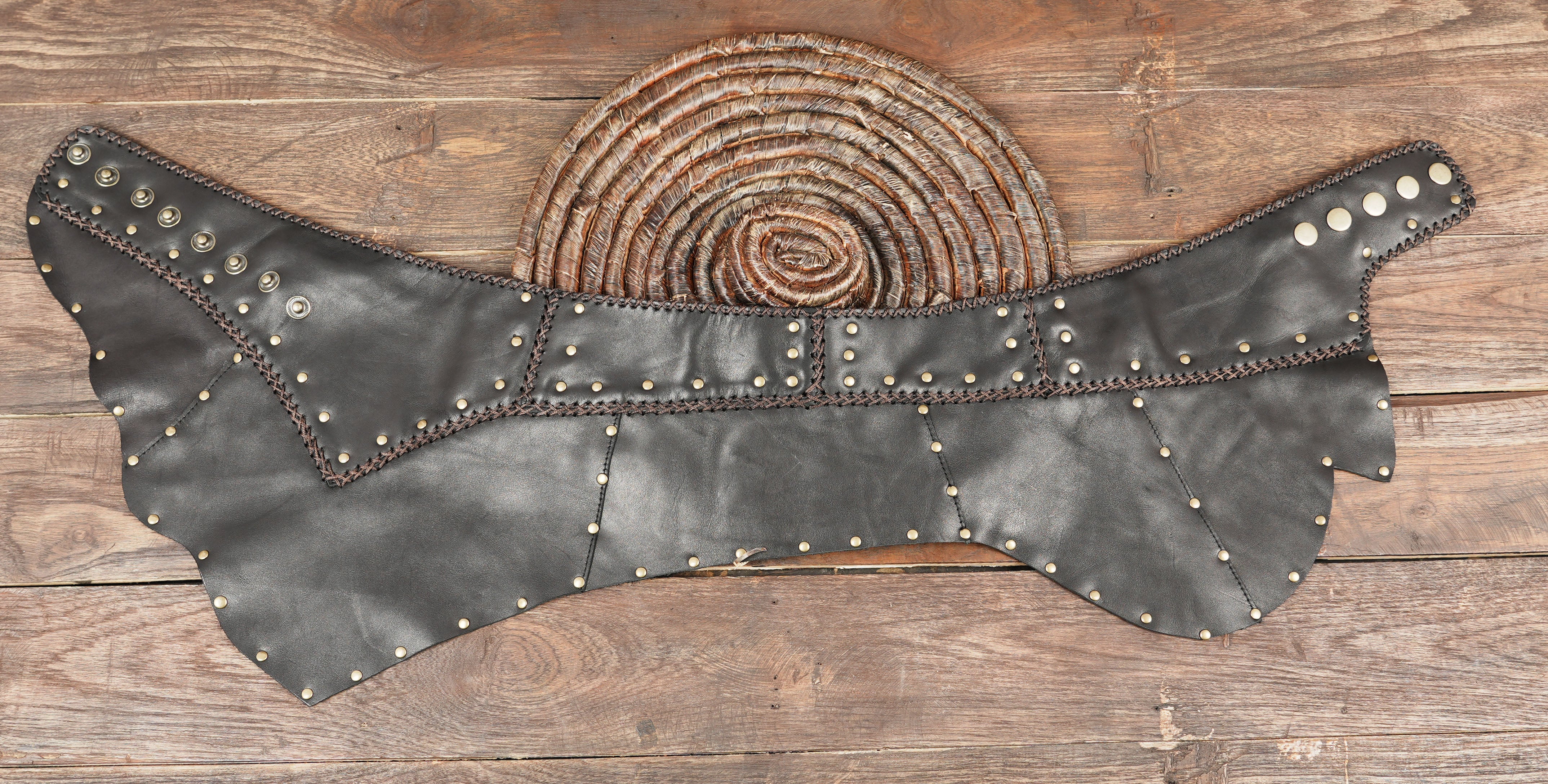 “Unique handmade leather skirt with brass rivets, rustic stitching, and vintage gothic style.