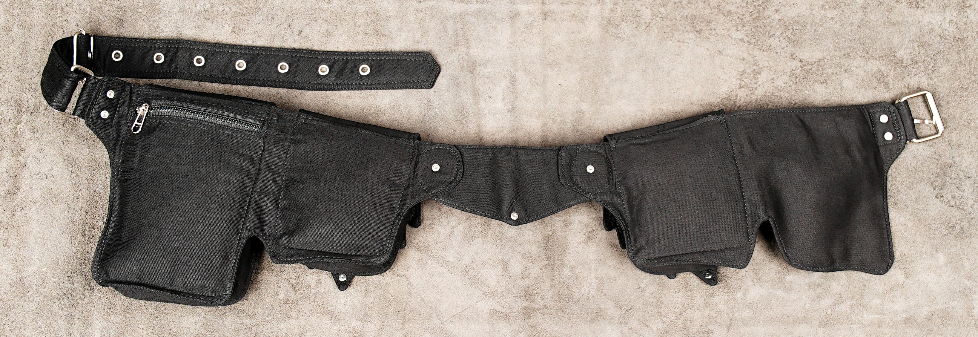Bike messenger style utility belt with multiple pouches and adjustable strap.