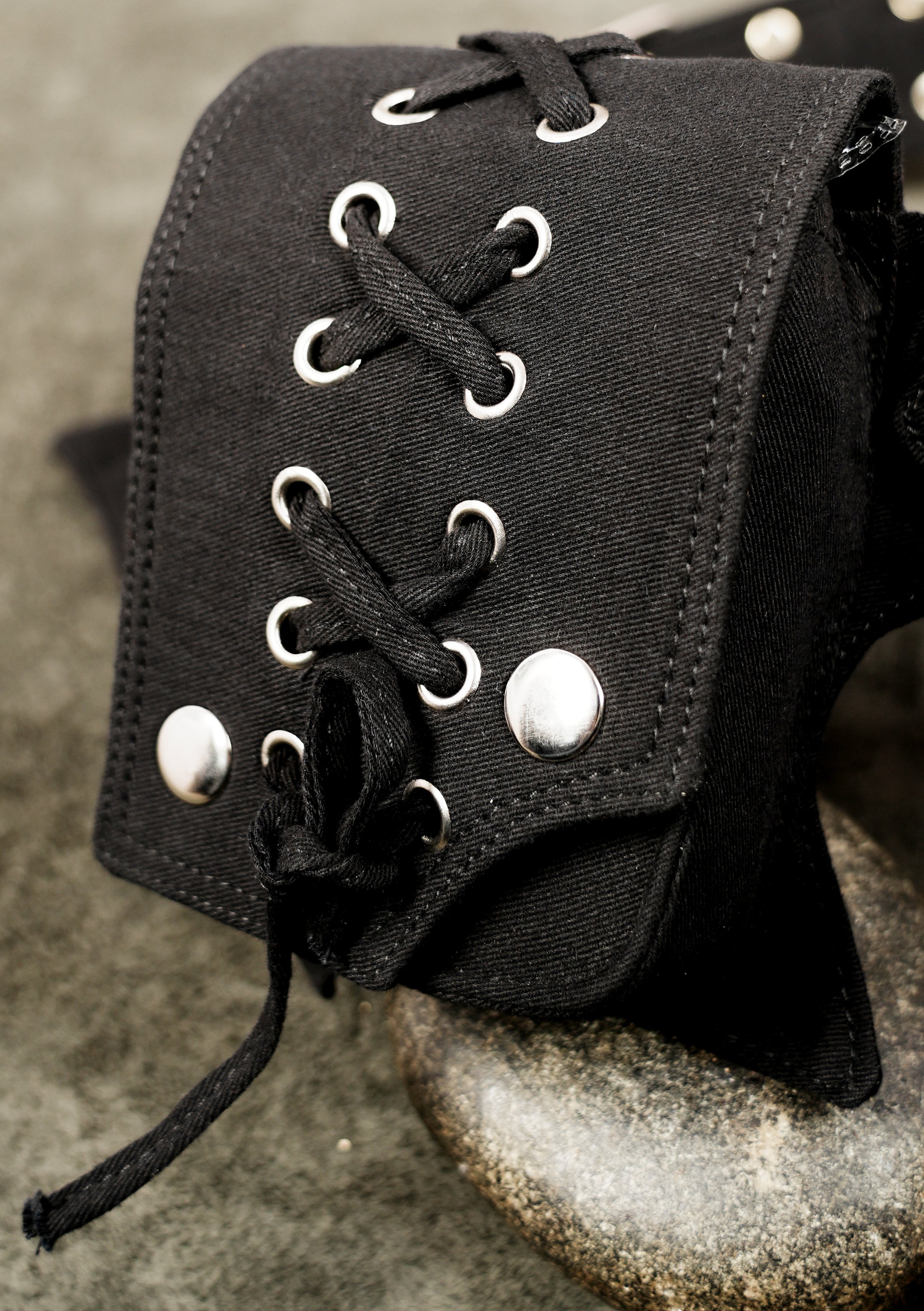 Unisex black pocket belt with silver grommets and roller buckle