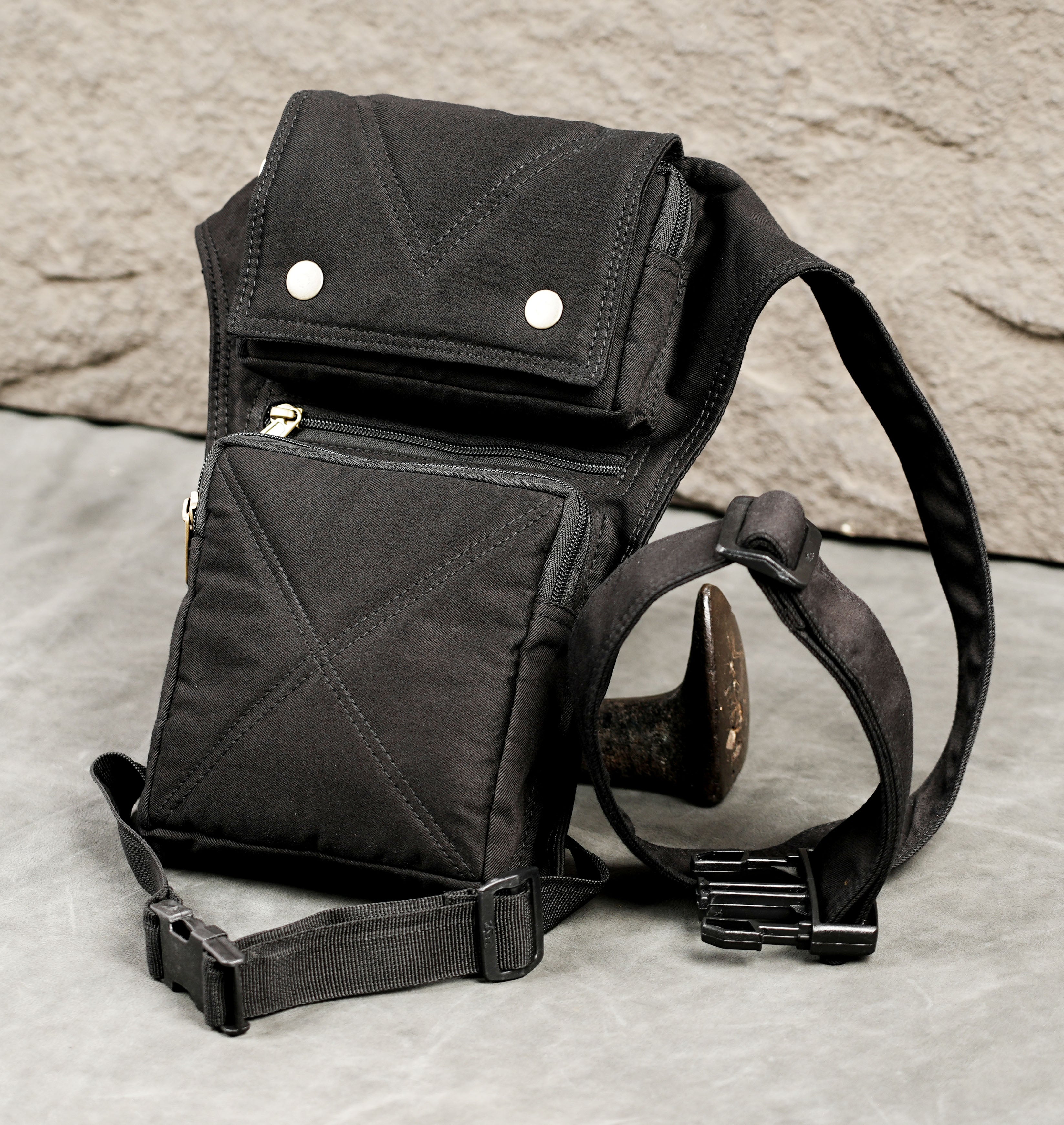 Black cotton leg bag with gold zipper and silver snap buttons